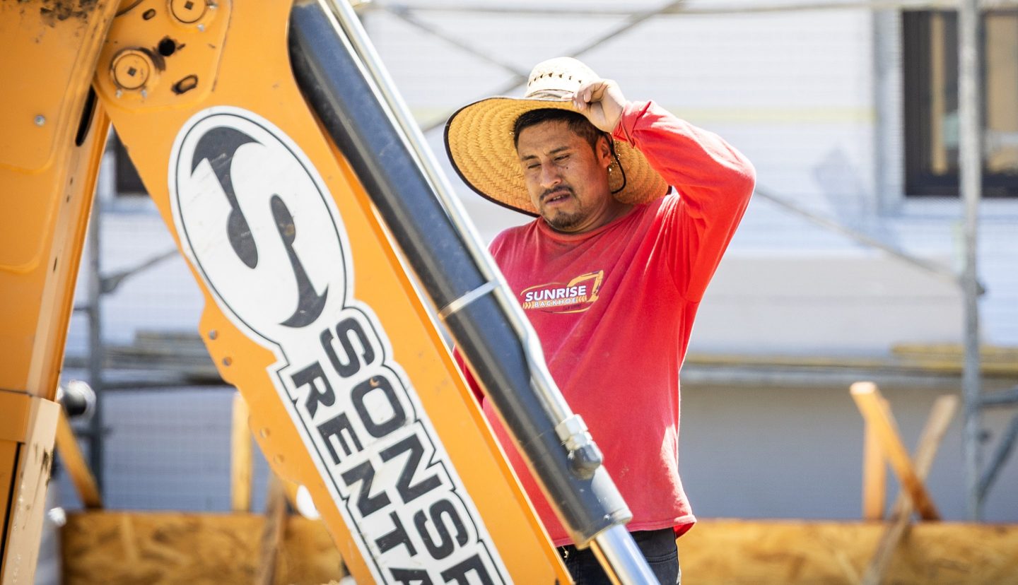 A construction worker tries to stay cool amid a heat wave while working on new homes in Irvine Wednesday, Aug. 20, 2025.