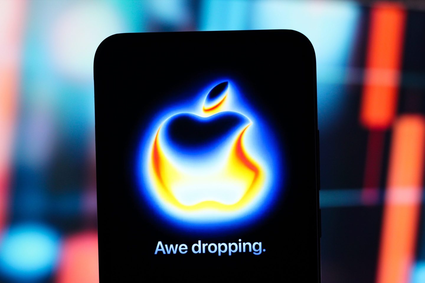 Smartphone screen displaying Apple's "Awe dropping" logo for its hardware announcement show later today.