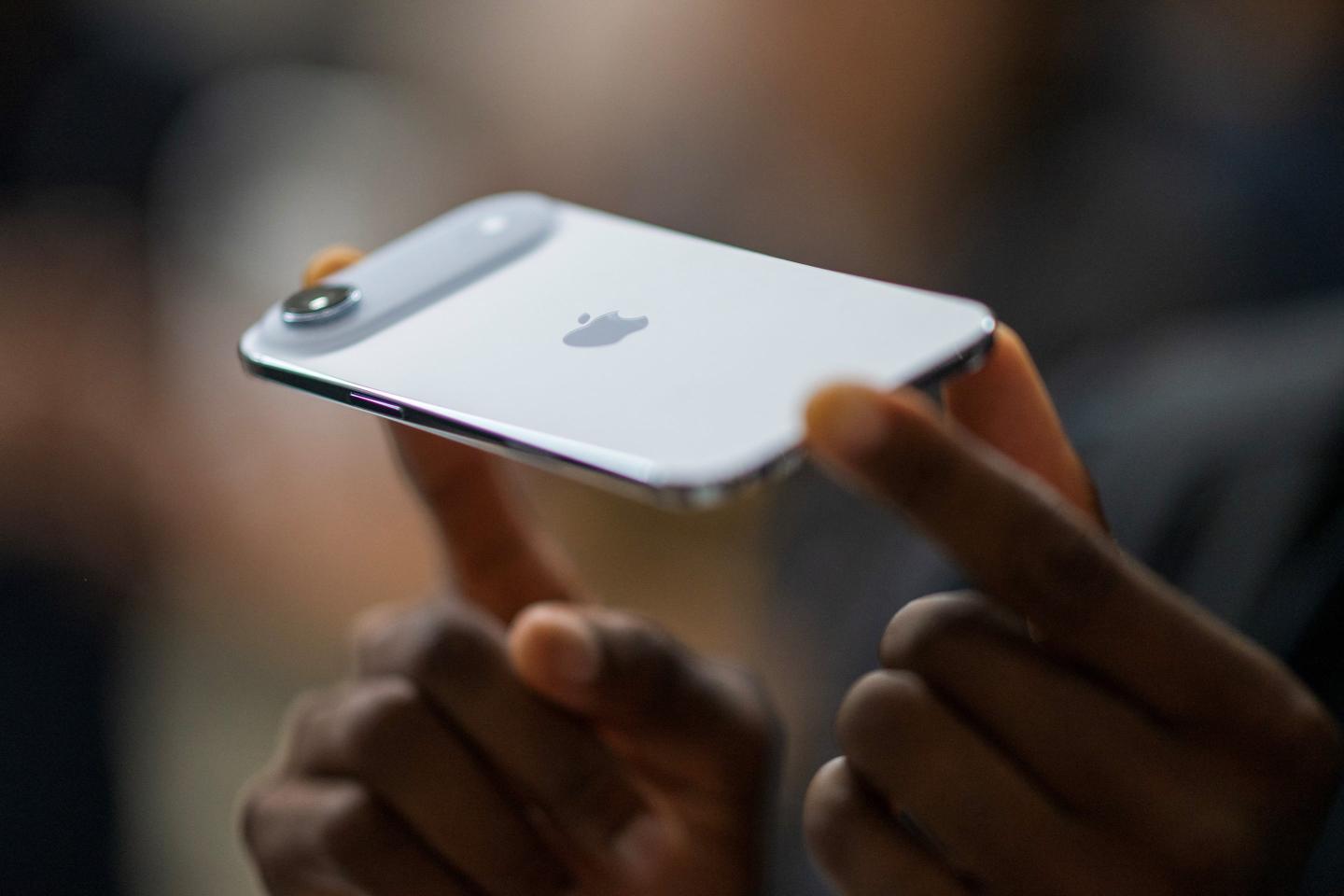 A person holds an iPhone Air