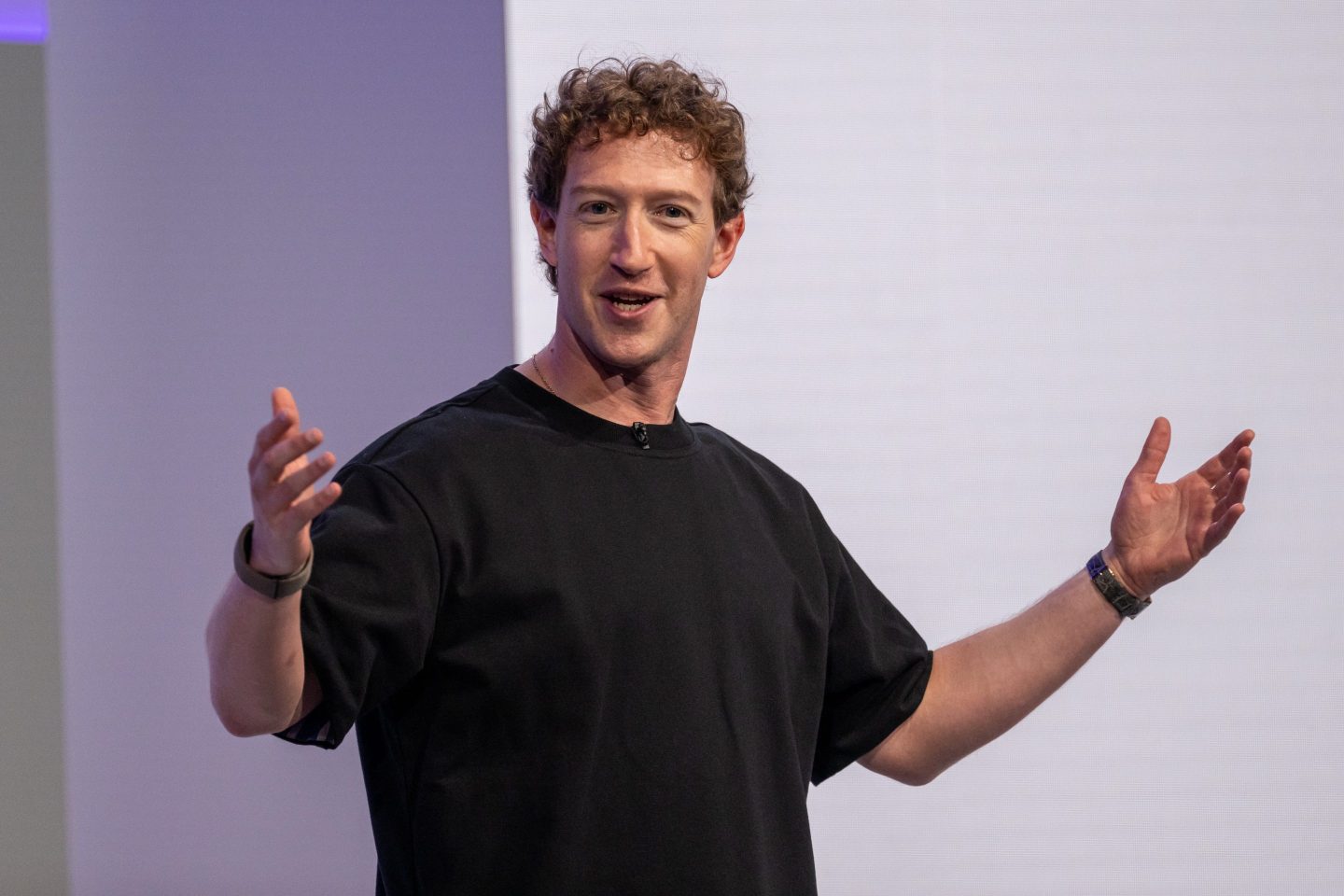 Mark Zuckerberg gestures and speaks on stage