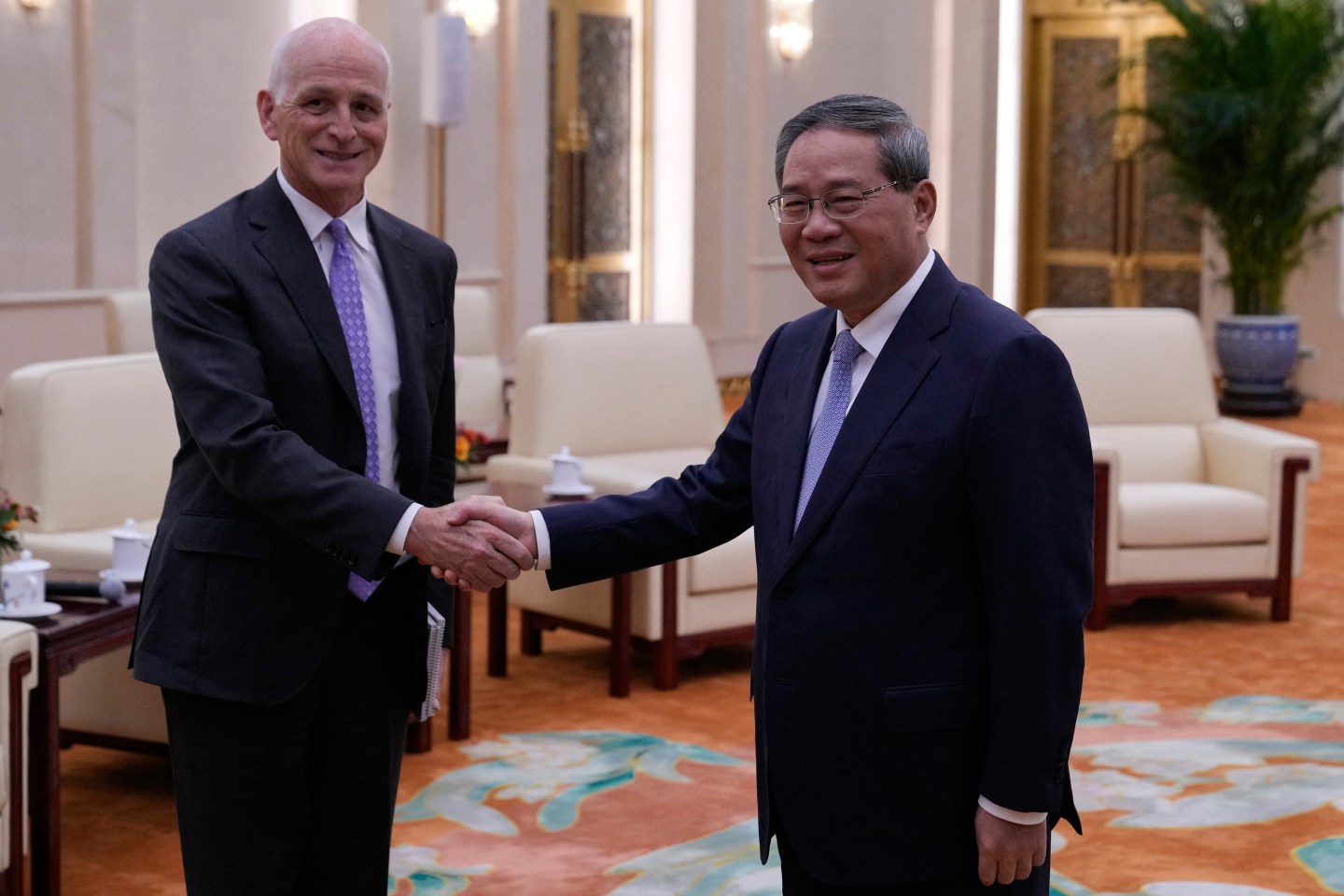 US Representative Adam Smith (L), D-Washington, ranking member of the House Armed Services Committee, shakes hands with Chinese Premier Li Qiang (R) at the Great Hall of the People in Beijing on September 21, 2025.