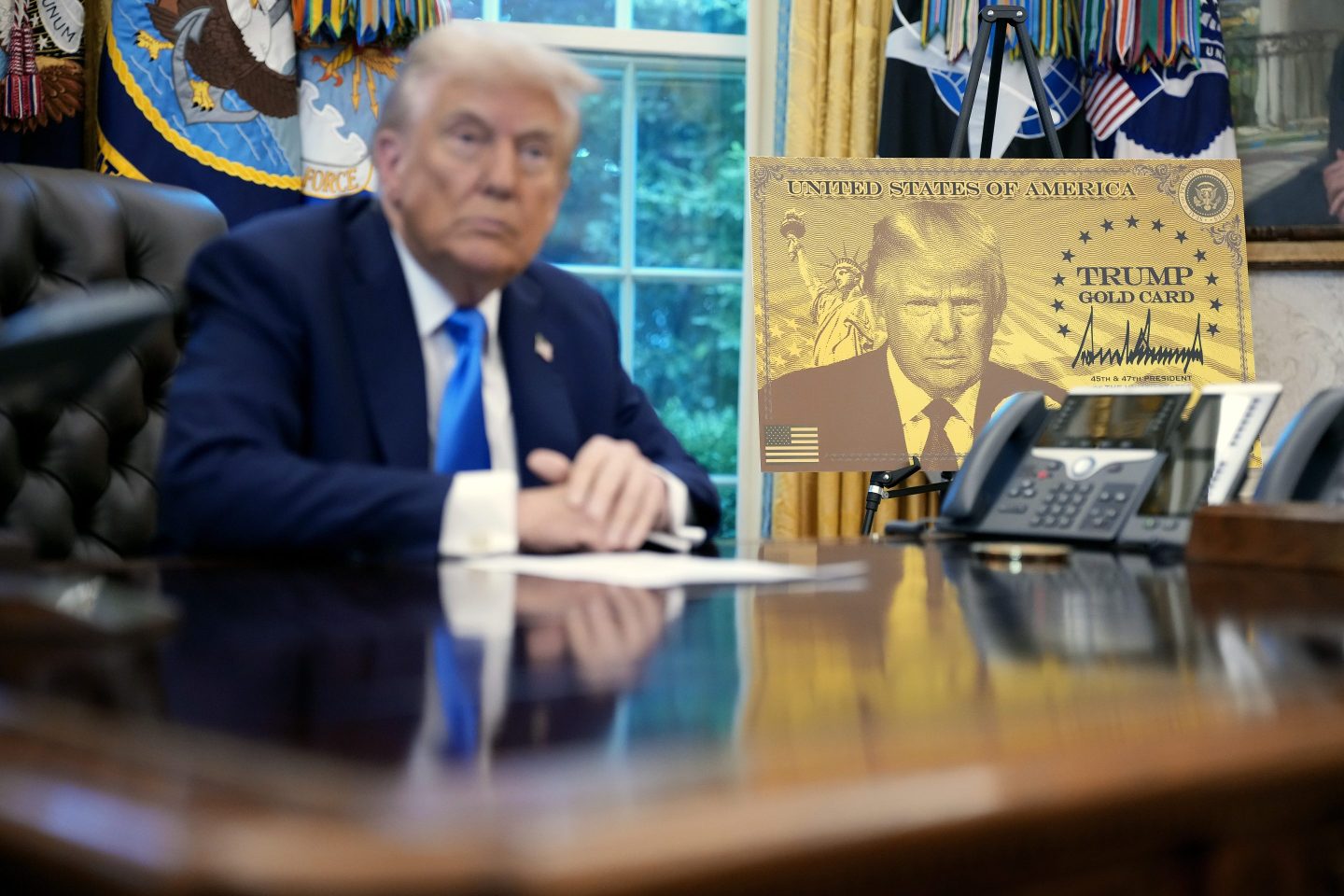 WASHINGTON, DC - SEPTEMBER 19: President Donald Trump delivers remarks alongside a poster of the "Trump Gold Card" before signing an executive order in the Oval Office at the White House on September 19, 2025 in Washington, DC. The "Trump Gold Card" is a visa that allows foreign nationals permanent residency and a pathway to U.S. citizenship for $5 million investment in the United States. (Photo by Andrew Harnik/Getty Images)