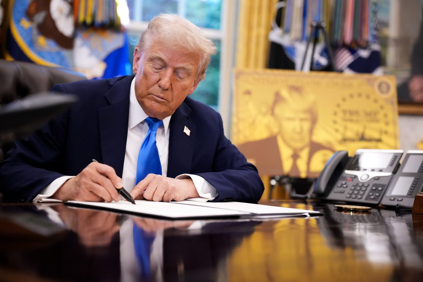 President Donald Trump signs an executive order in the Oval Office at the White House on September 19, 2025 in Washington, DC.