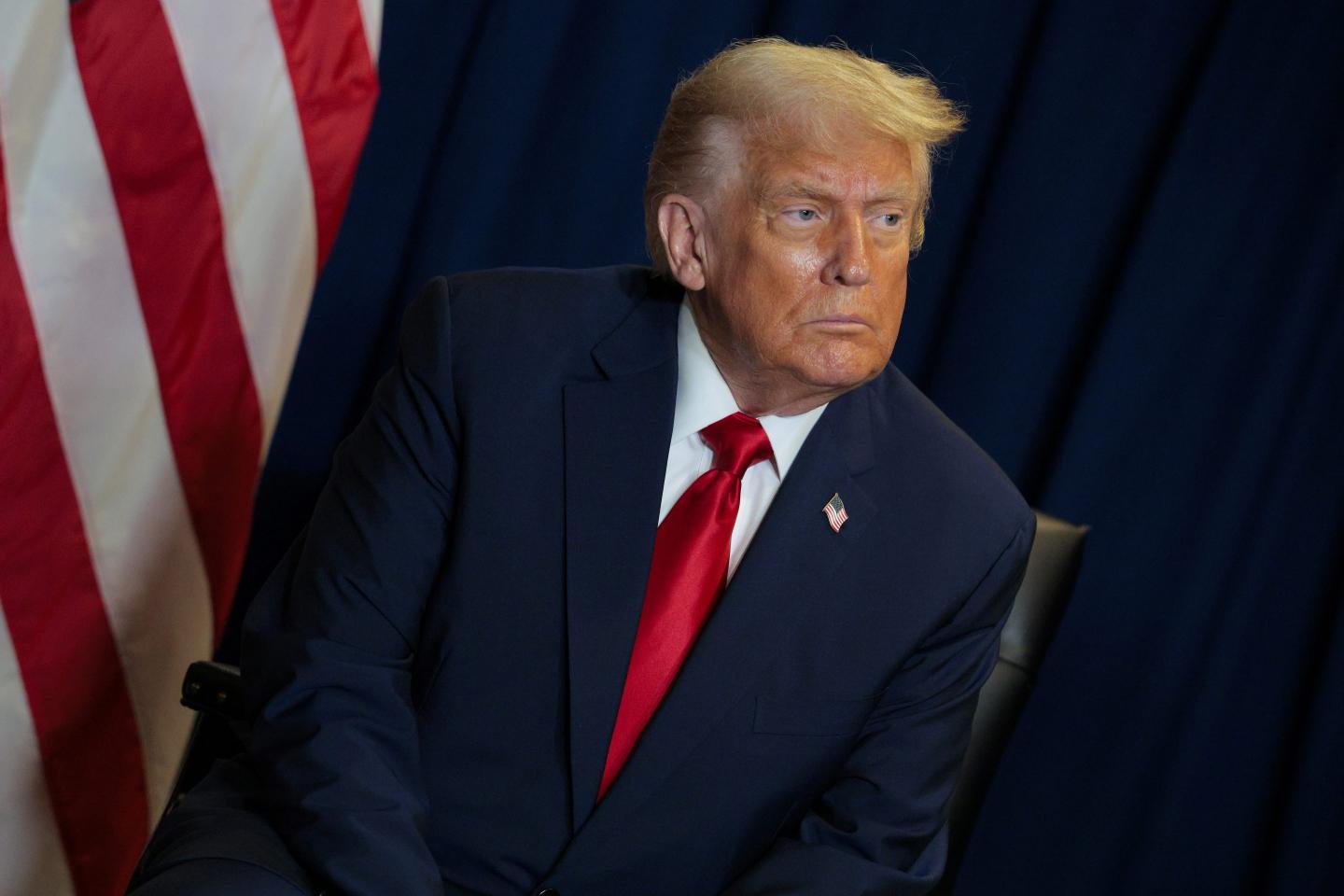 Donald Trump looks to his left, frowning