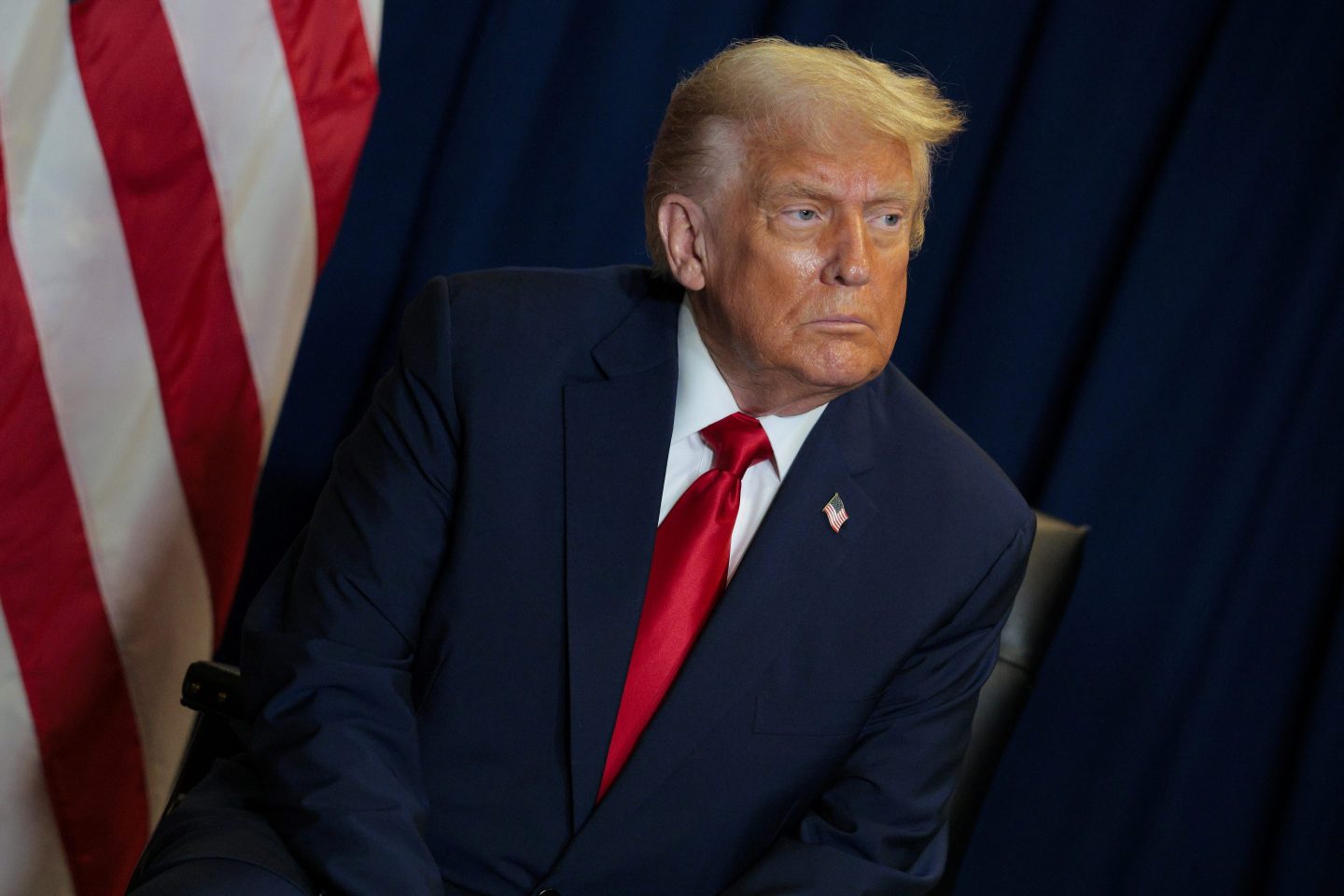 Donald Trump looks to his left, frowning