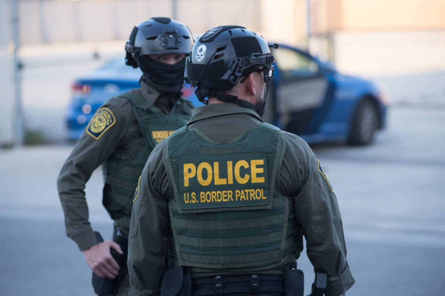 U.S. Immigration and Customs Enforcement (ICE) agents, Department of Homeland Security (DHS) personnel, and Border Patrol Commander Gregory Bovino stand together amidst a tense protest outside the ICE processing facility in Broadview, Illinois, on September 27, 2025.