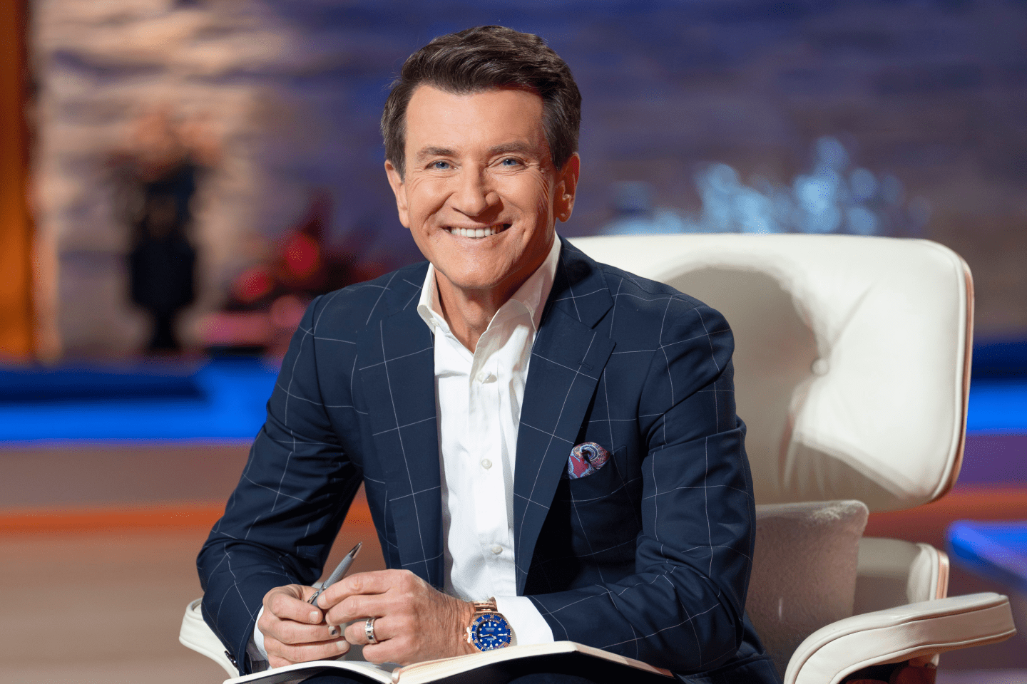Robert Herjavec sitting on the set of Shark Tank