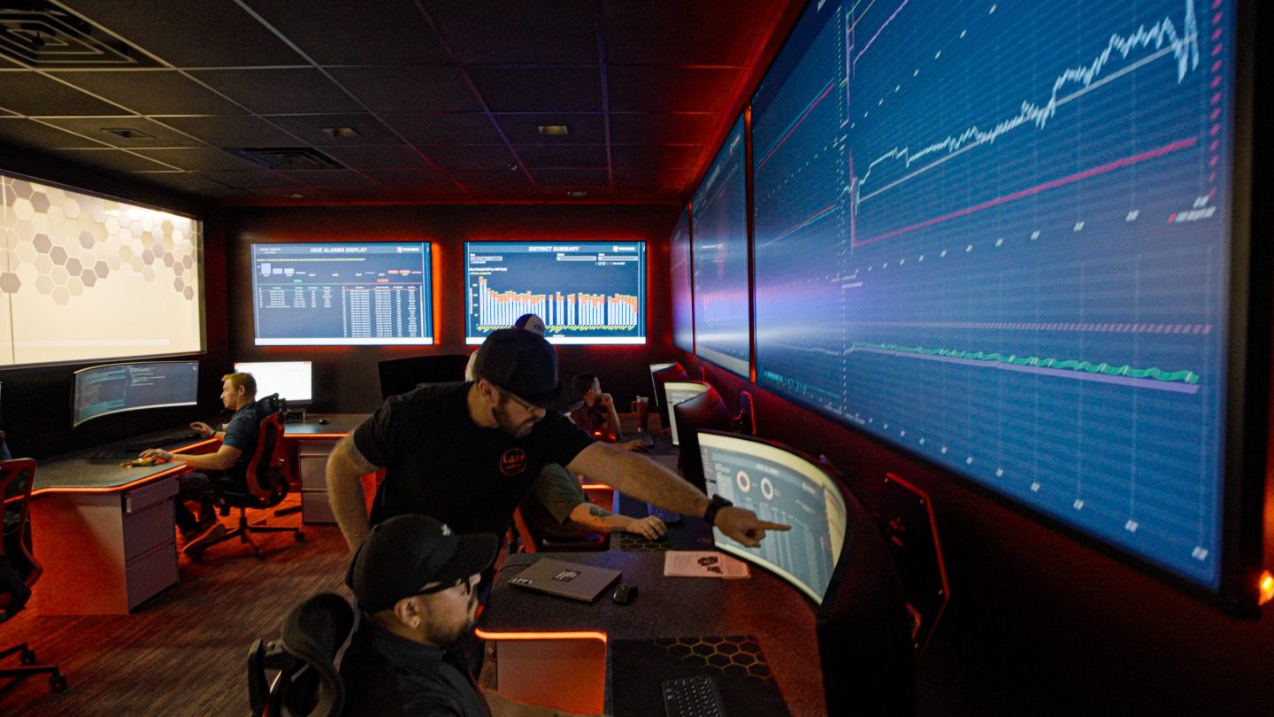 Employees are shown at Liberty Energy's Hive tech center near Denver where all of the frac fleet operations nationwide are monitored remotely.