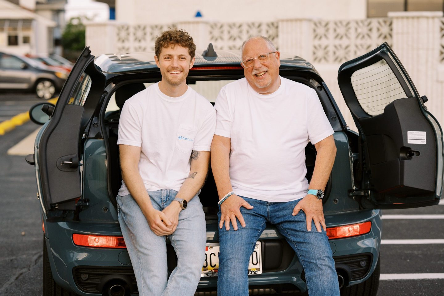 Zach Shefska sits on the back of his car with his dad, Ray
