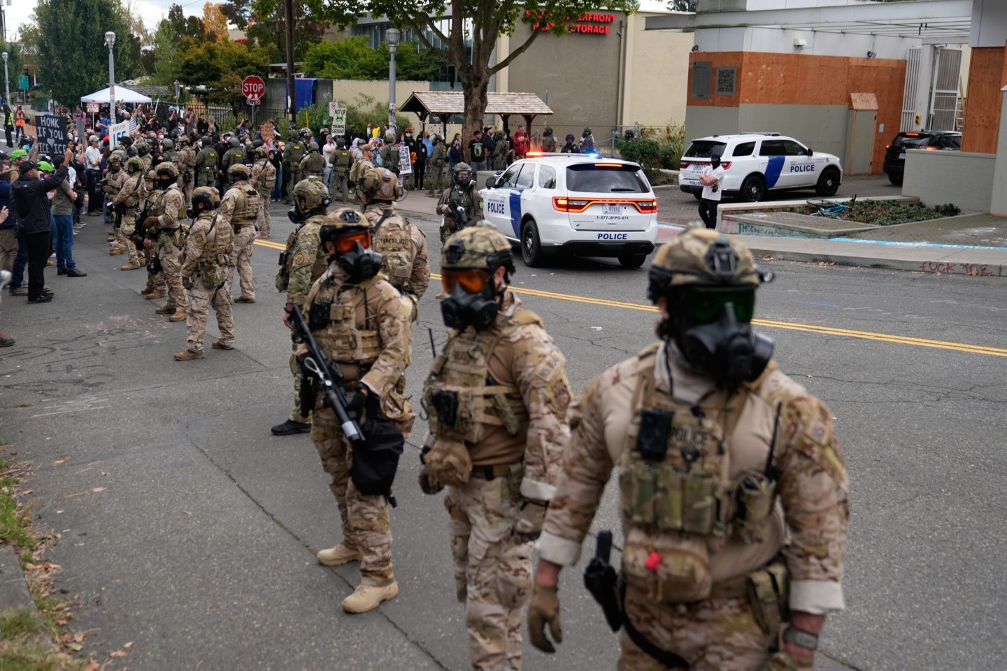 Customs and Border Protection agents stand outside a U.S. Immigration and Customs Enforcement facility during a protest in Portland, Ore.