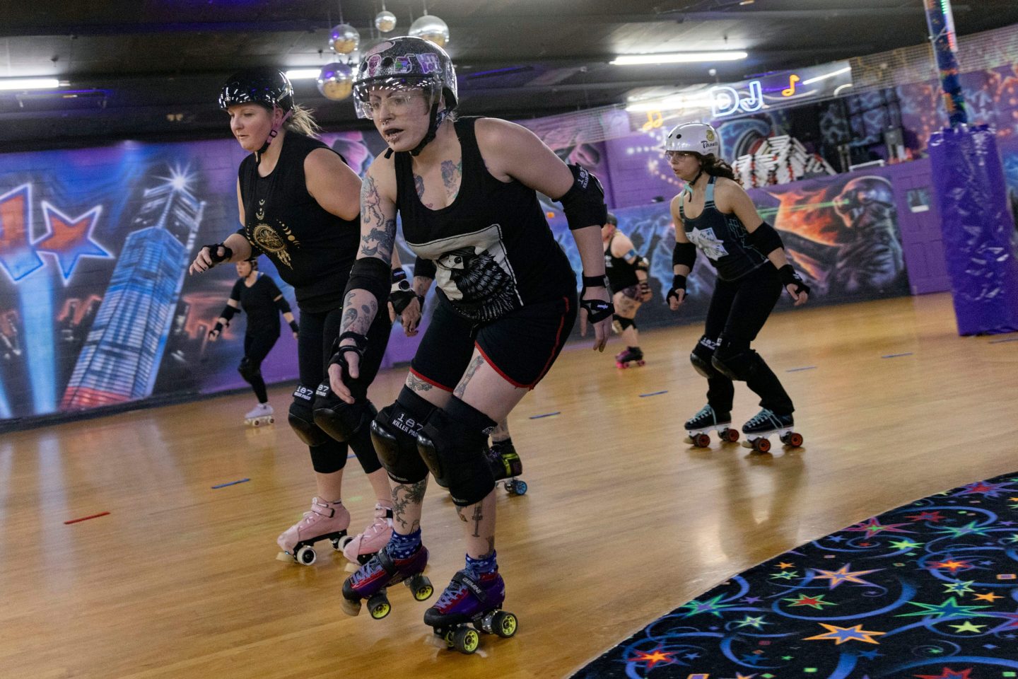 Girls on rollerskates practicing derby.
