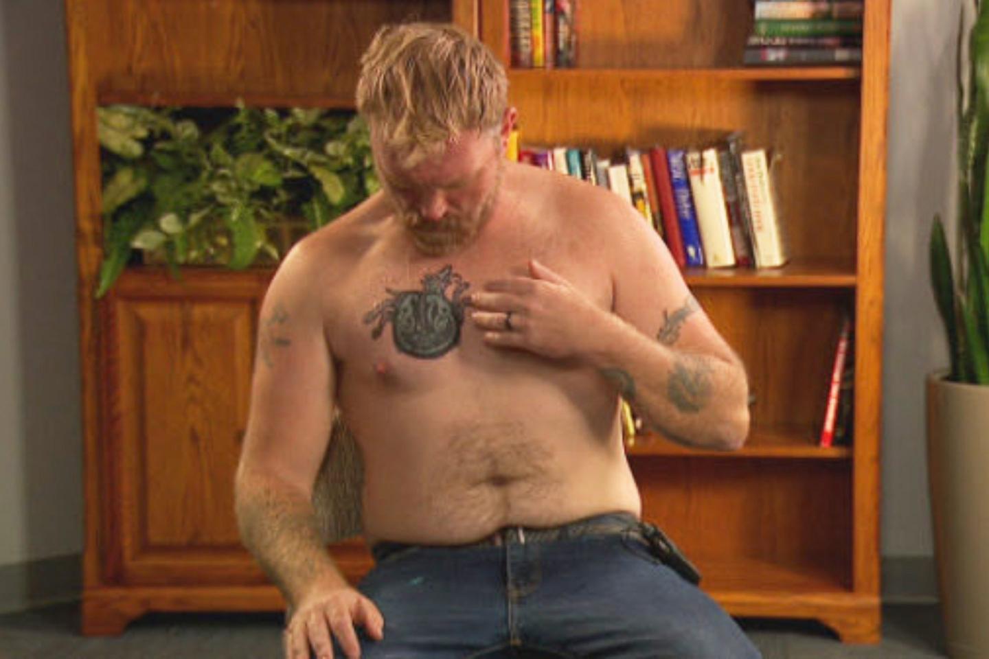 Graham Platner, a democratic candidate for U.S. Senate, points to a cover-up tattoo that had previously been an image recognized as a Nazi symbol, during an interview on Wednesday, Oct. 22, 2025, in Portland, Maine.