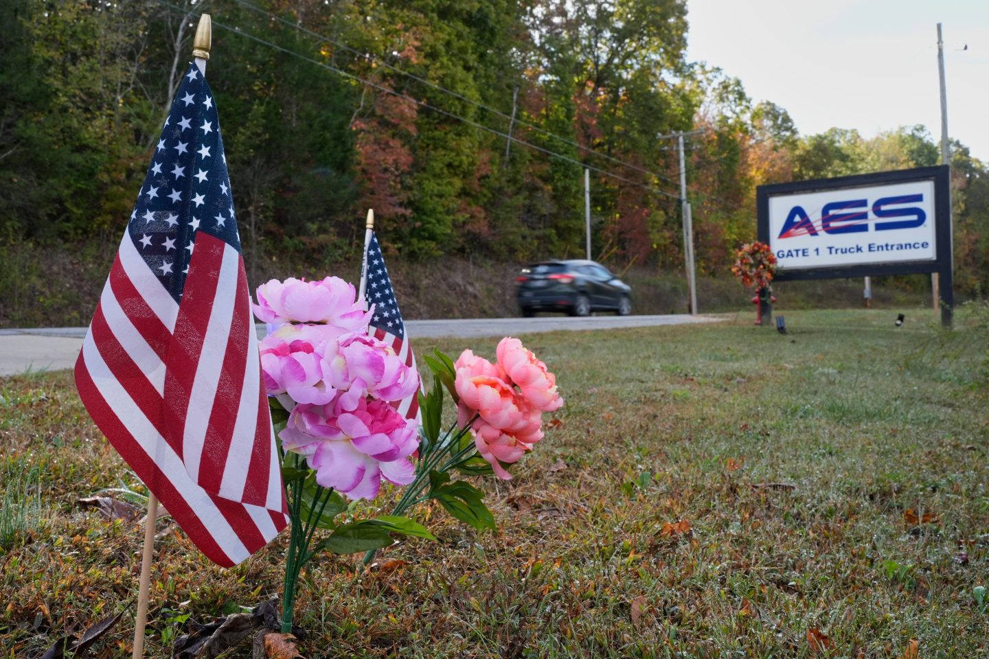 Flags and flowers are seen at the entrance to Accurate Energetic Systems on Friday.
