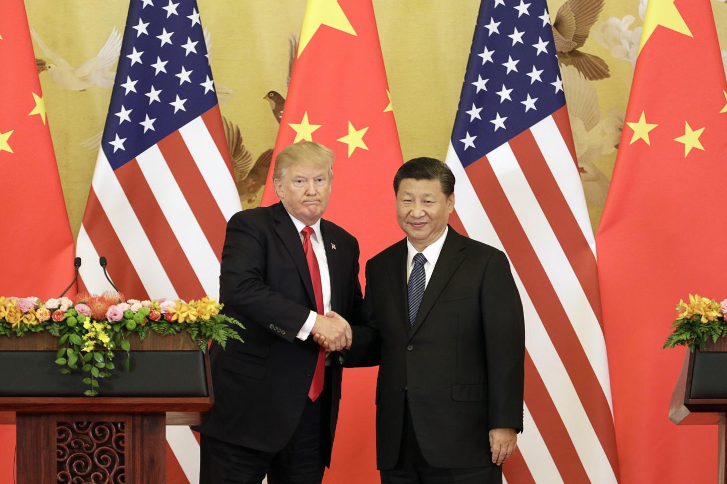 U.S. President Donald Trump, left, and Xi Jinping, China's president, shake hands during a news conference at the Great Hall of the People in Beijing, China, on Thursday, Nov. 9, 2017.