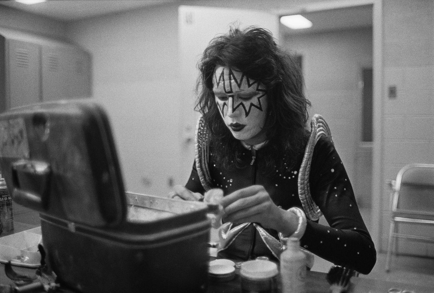 Guitarist Ace Frehley from American rock group Kiss attends to his make-up backstage at Cobo Hall in Detroit during the concert recording of Alive! on 16th May 1975.