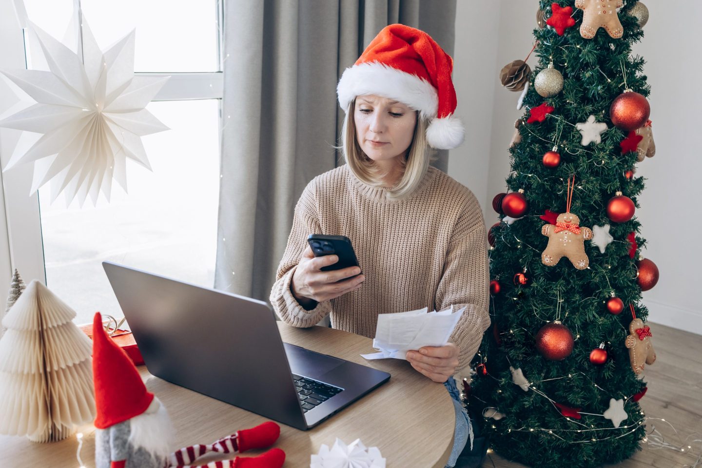 Young woman looking stressed while going through various expense receipts and bills after Christmas shopping. Planning budget, calculating expenses and managing financial bills at home