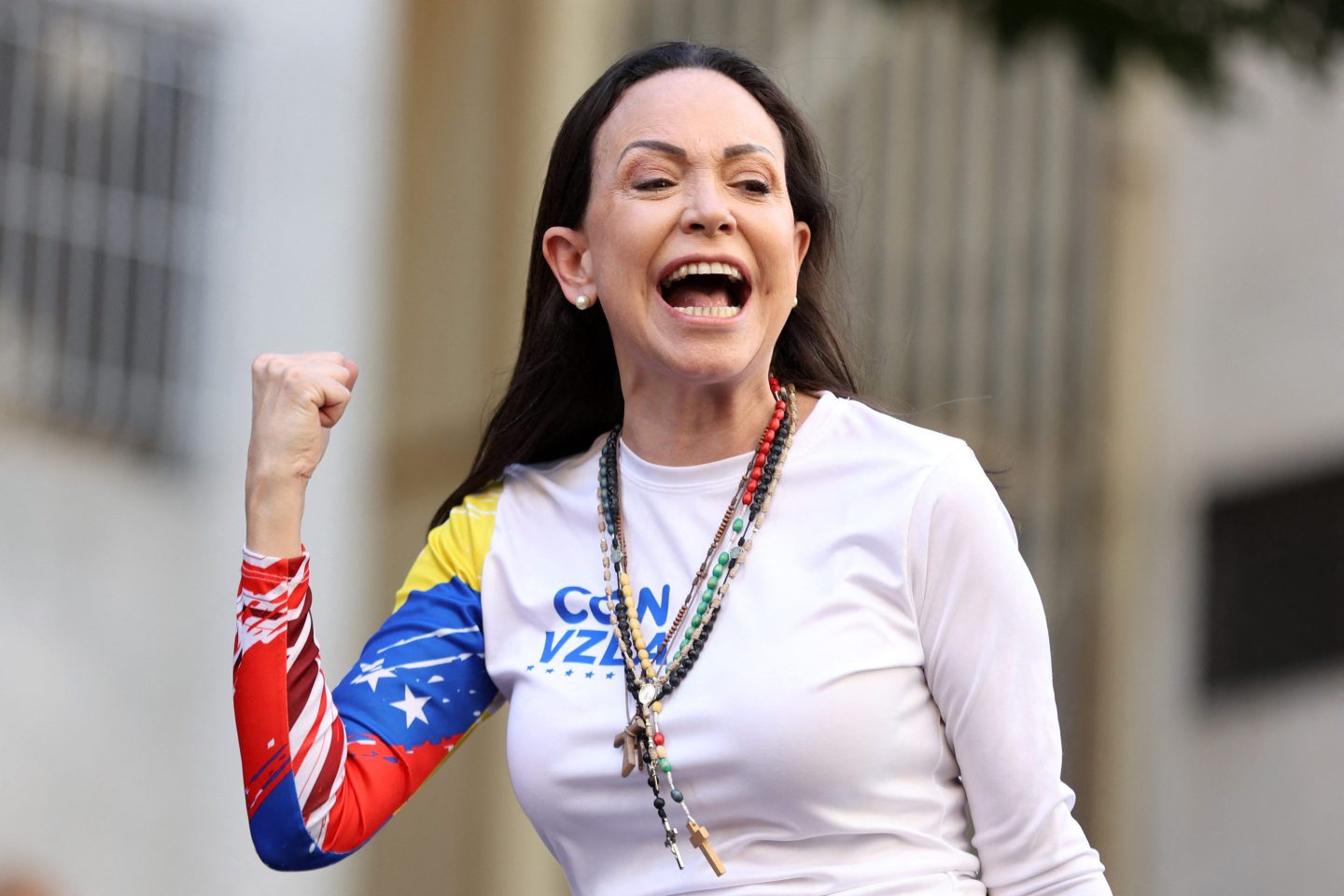 Maria Corina Machado raises a fist in celebration