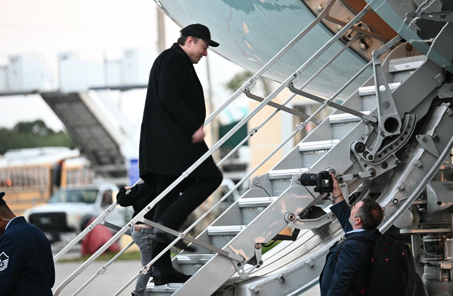 Elon Musk boarding a plane.
