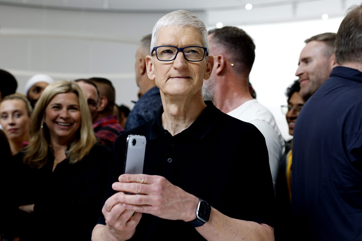 Apple CEO Tim Cook not looking too pleased holding the iPhone Air