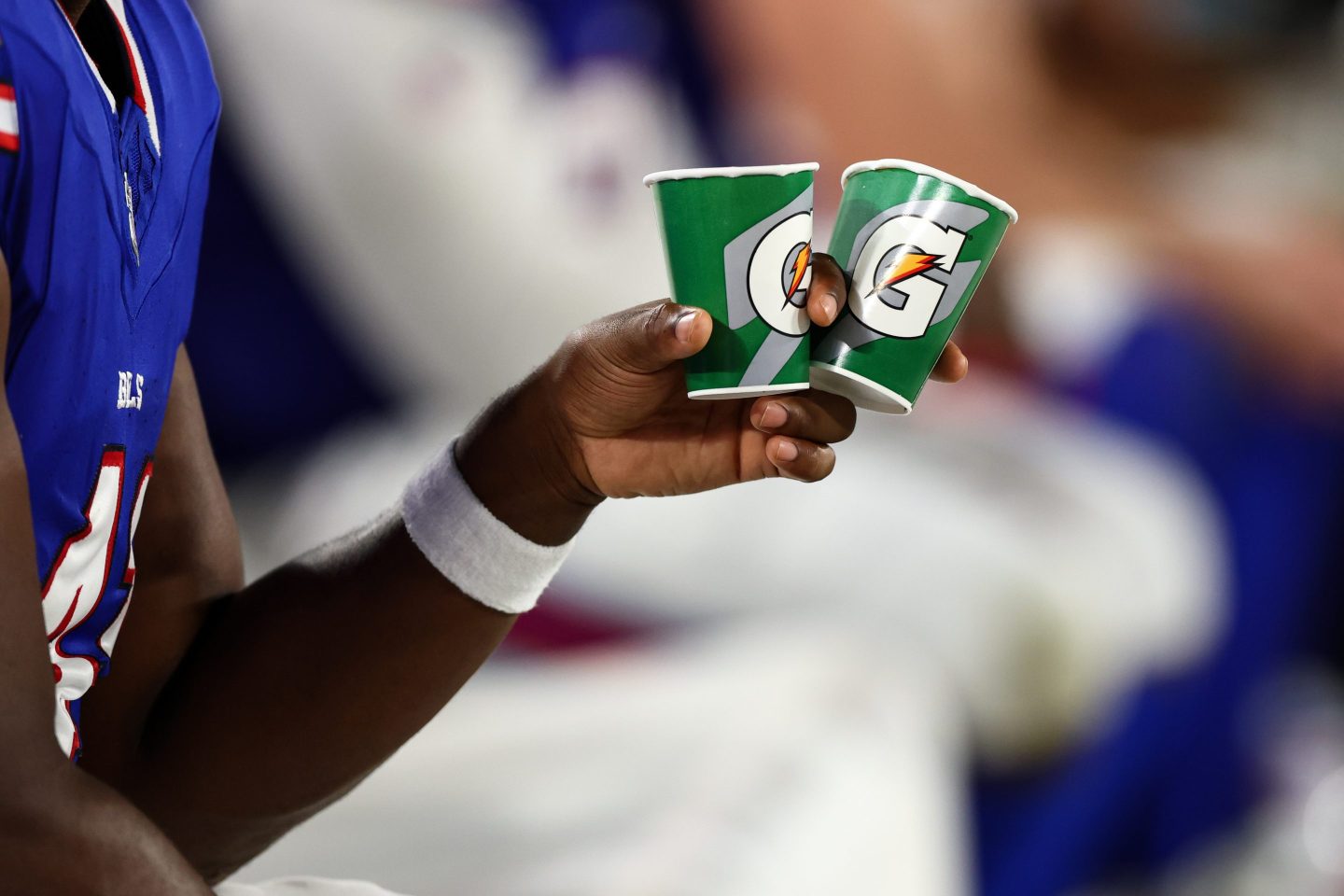 A Buffalo Bills player holds Gatorade cups on the sidelines during an NFL preseason football game against the Tampa Bay Buccaneers at Raymond James Stadium on August 23, 2025 in Tampa, Florida.