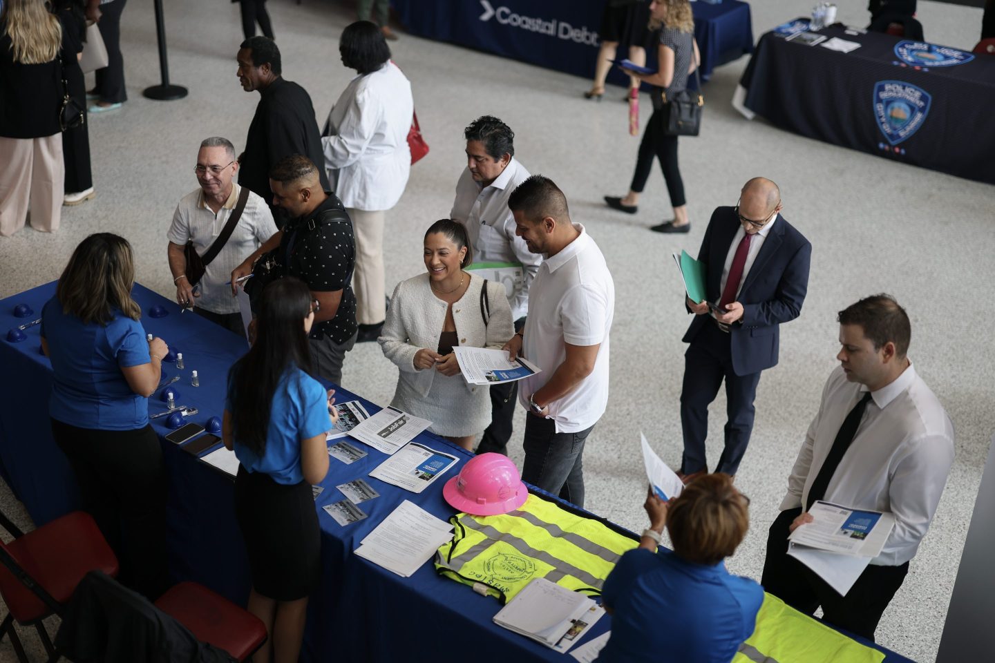 SUNRISE, FLORIDA - SEPTEMBER 25: Job seekers inquire about jobs at the MasTec company booth during the Mega JobNewsUSA South Florida Job Fair held in the Amerant Bank Arena on September 25, 2025 in Sunrise, Florida. Hiring managers and recruiters attended the job fair to recruit workers for some of the positions businesses are trying to fill in Miami, Broward, and Palm Beach Counties. (Photo by Joe Raedle/Getty Images)