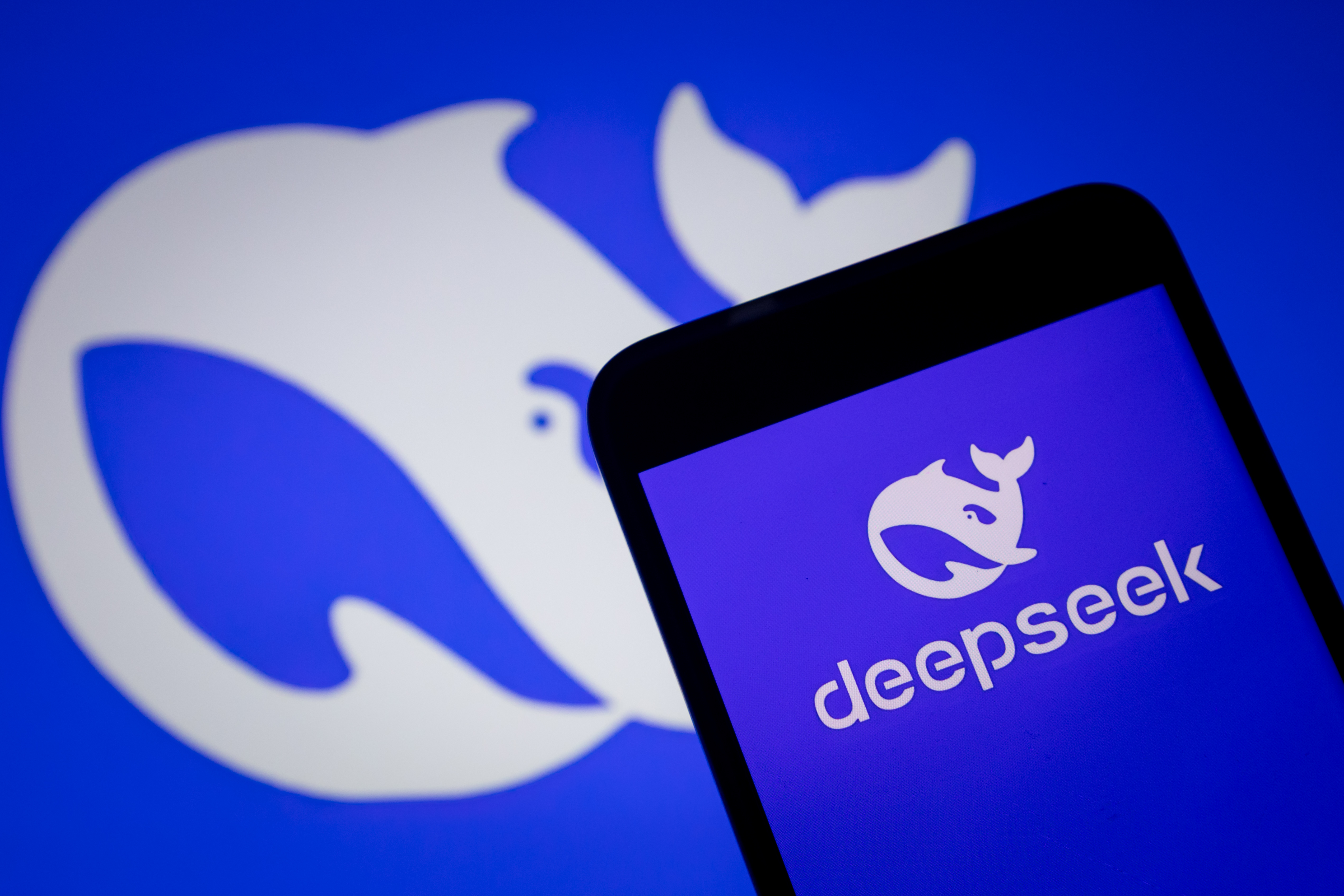 DeepSeek logo on phone and background.