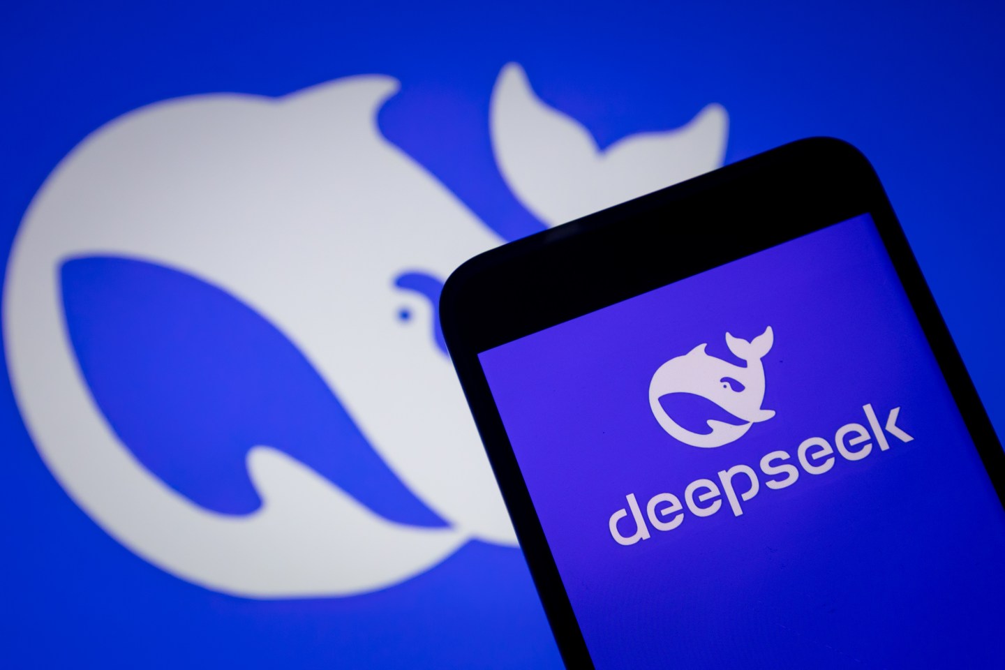 DeepSeek logo on phone and background.