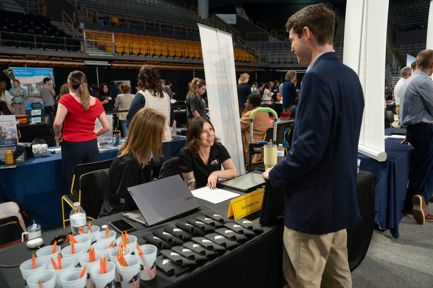 Recruiters speak to a job seeker at the Appalachian State University internship and job fair in Boone, North Carolina, US, on Wednesday, Oct. 1, 2025