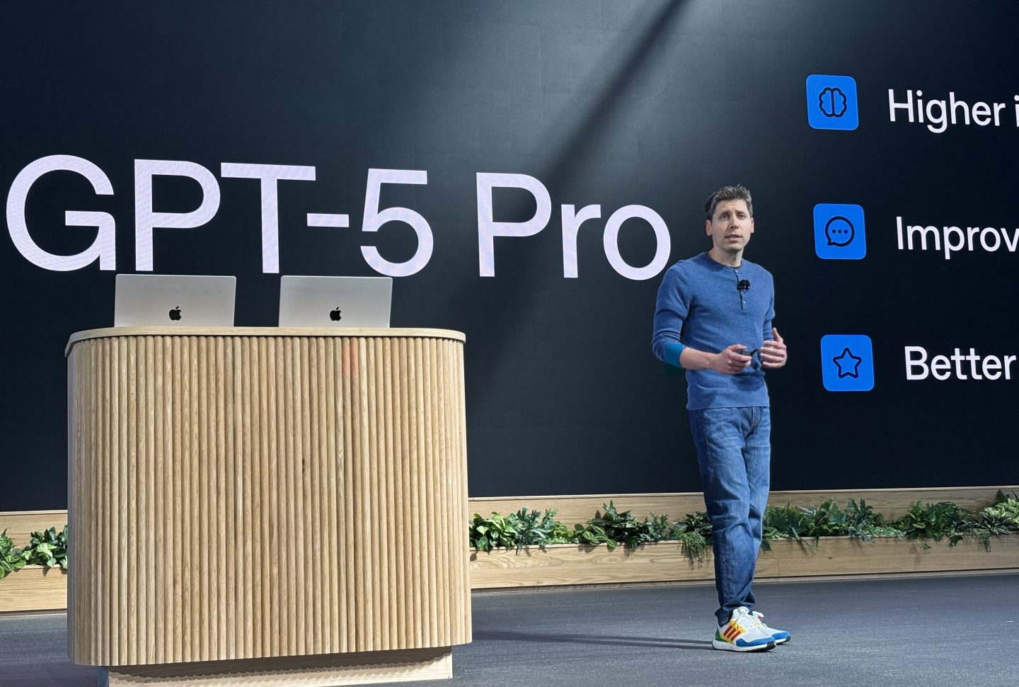 OpenAI CEO Sam Altman on stage in front of a sign that says "GPT-5 Pro" at the company's DevDay on October 6, 2025.