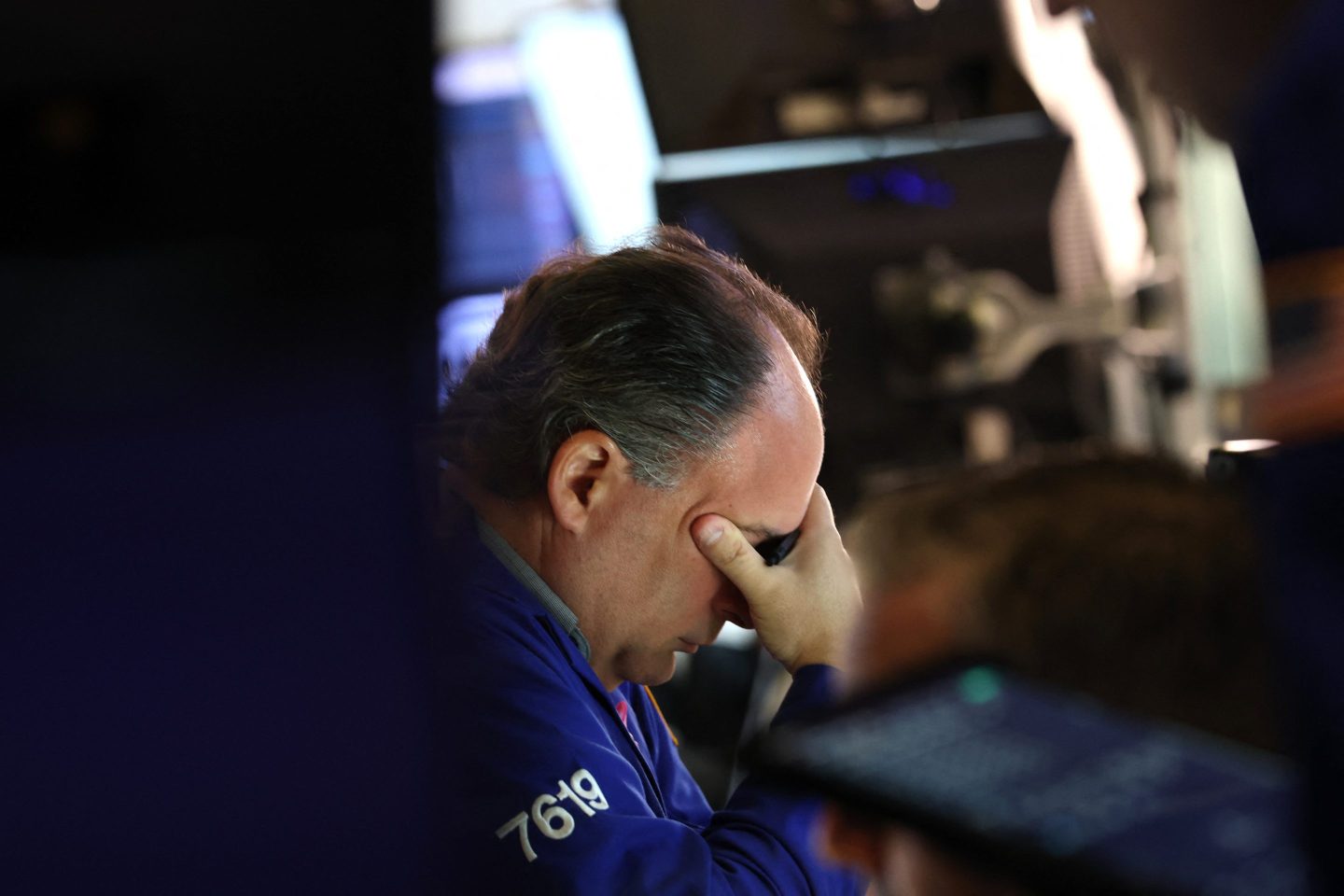 A trader works at his desk on the floor of the New York Stock Exchange (NYSE) in New York on October 7, 2025