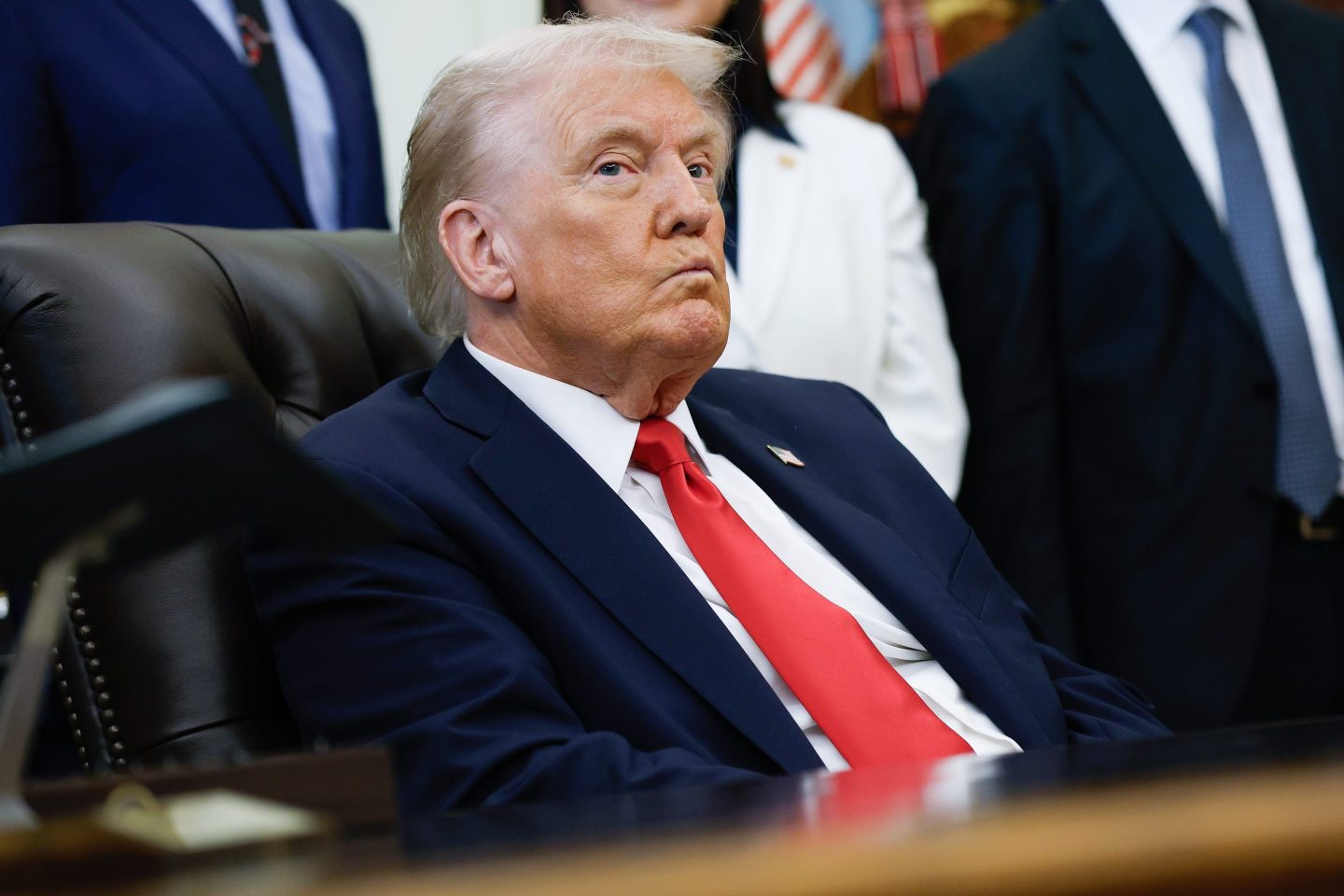 President Donald Trump listens to other speakers after delivering remarks during an event in the Oval Office of the White House on October 16, 2025 in Washington, DC.