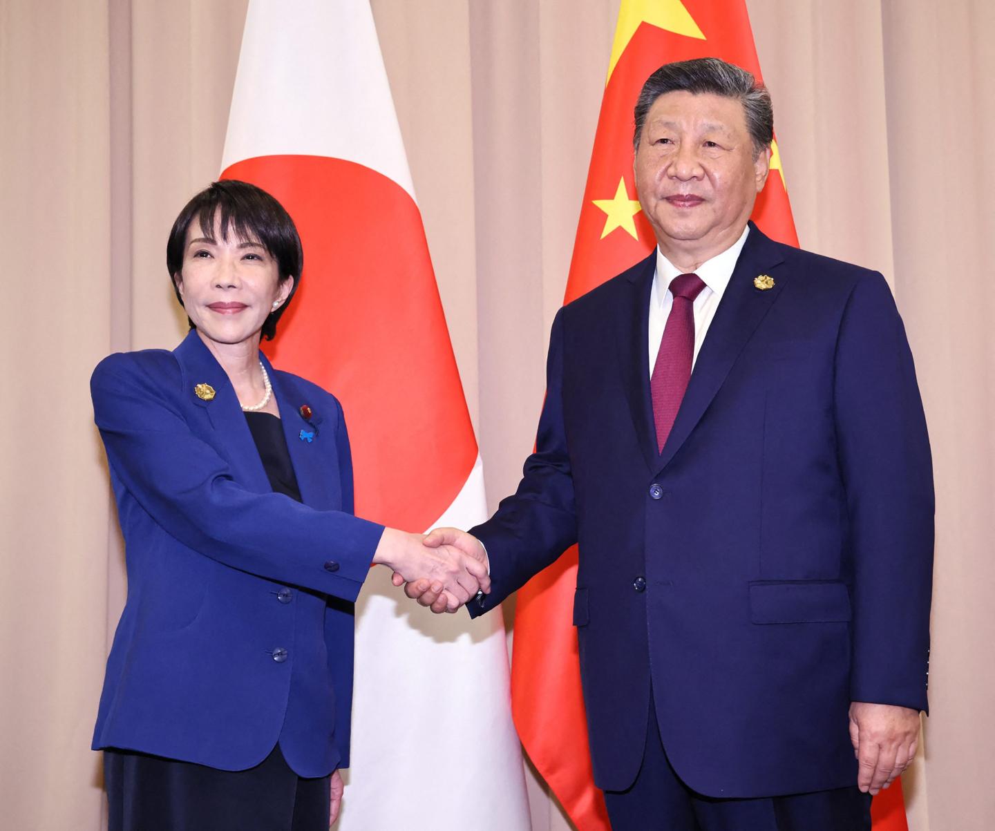 Japan's Prime Minister Sanae Takaichi (L) shakes hands with Chinese President Xi Jinping ahead of the Japan-China summit on the sidelines of the Asia-Pacific Economic Cooperation (APEC) Summit in Gyeongju on October 31, 2025.