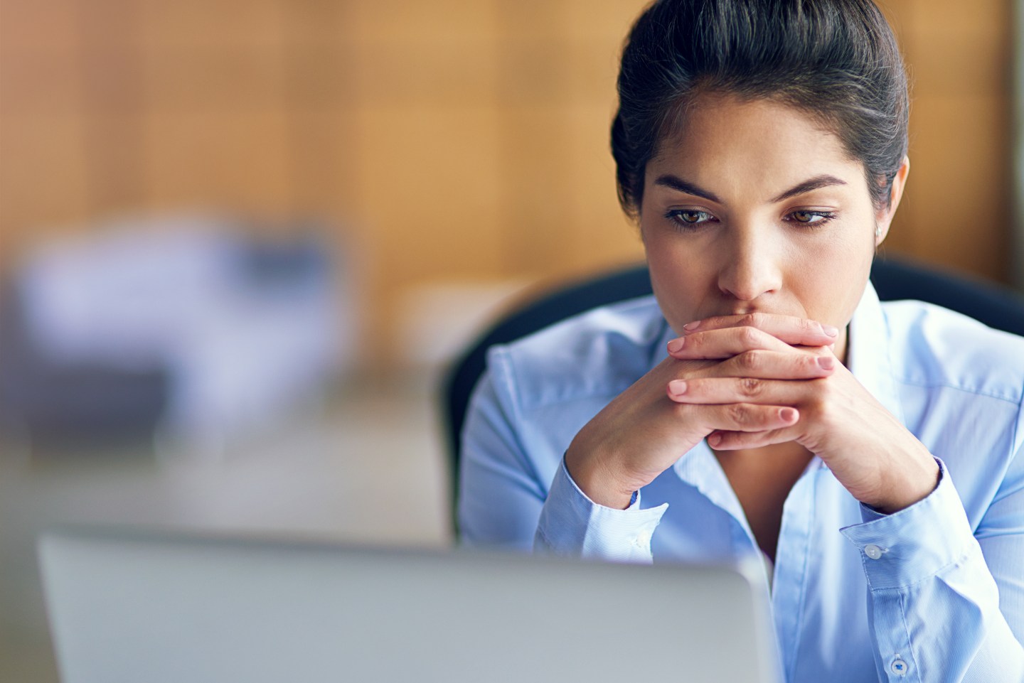 Businesswoman looking stressed while working on her computer.