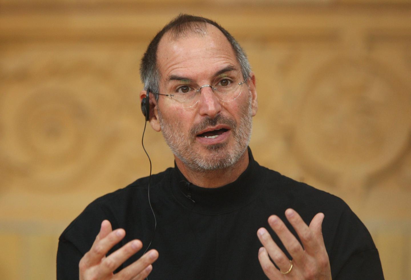 Steve Jobs holds up his hands while speaking