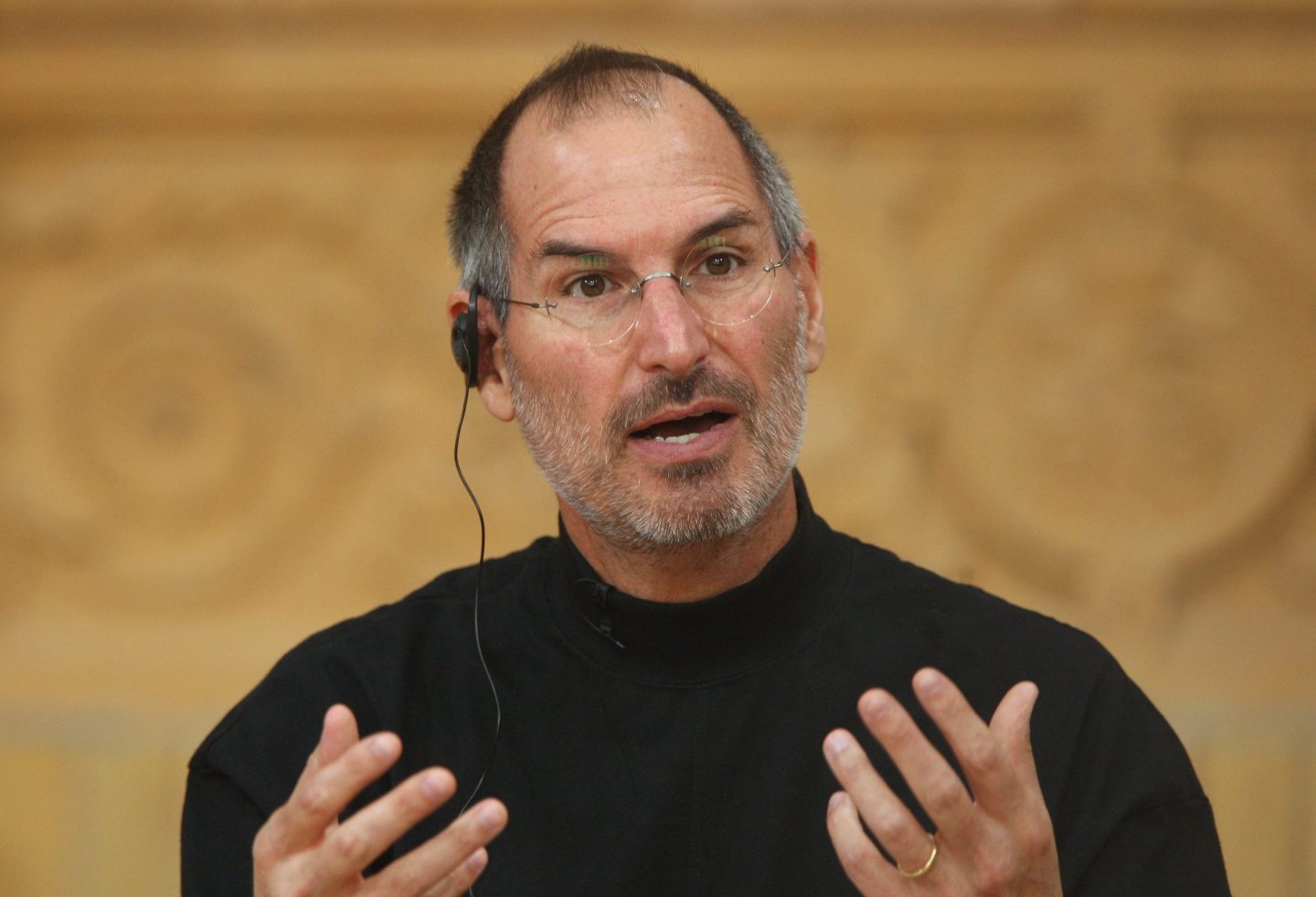 Steve Jobs holds up his hands while speaking