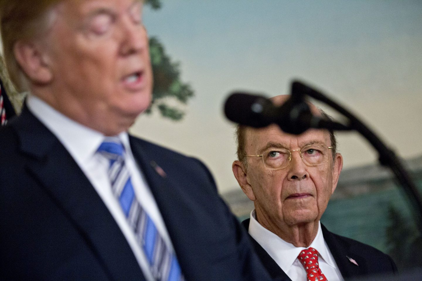 Wilbur Ross, U.S. commerce secretary, listens as U.S. President Donald Trump, left, speaks in the Diplomatic Room of the White House in Washington, D.C., U.S., on Friday, March 23, 2018.