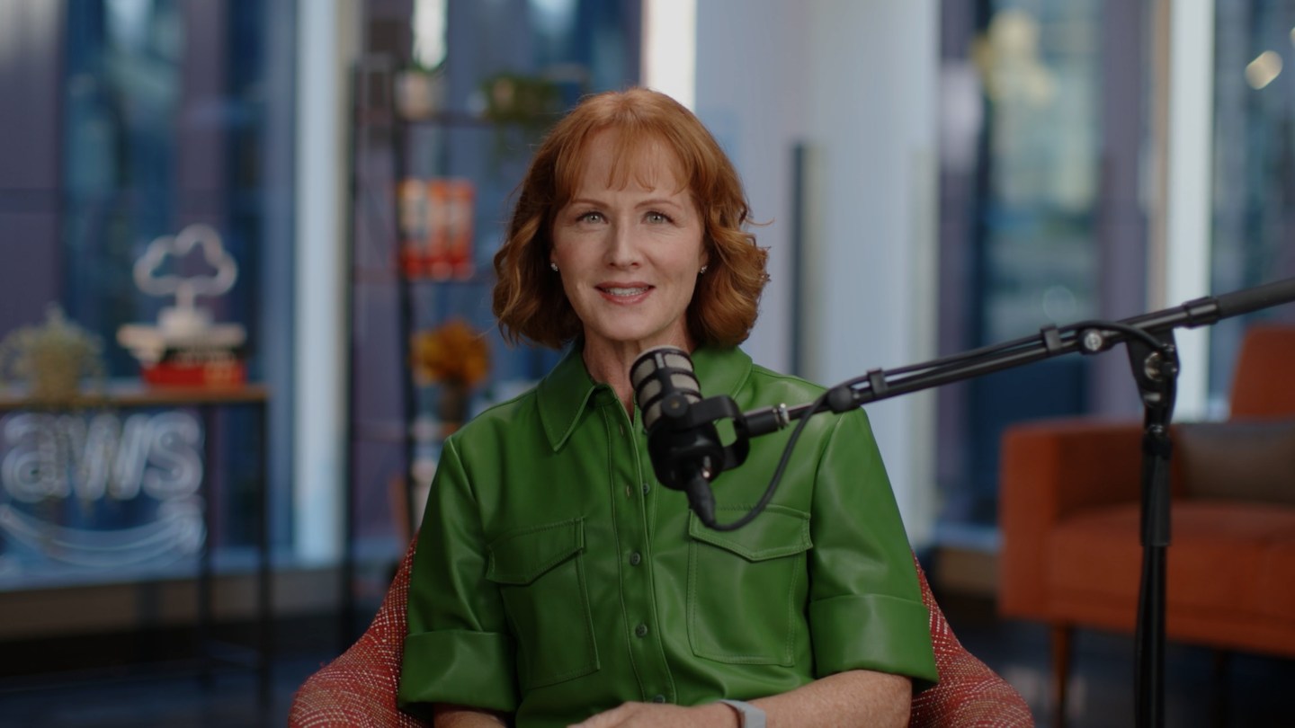 Julia White, the red-headed CMO of AWS, speaks into a podcast microphone at Amazon's studio.