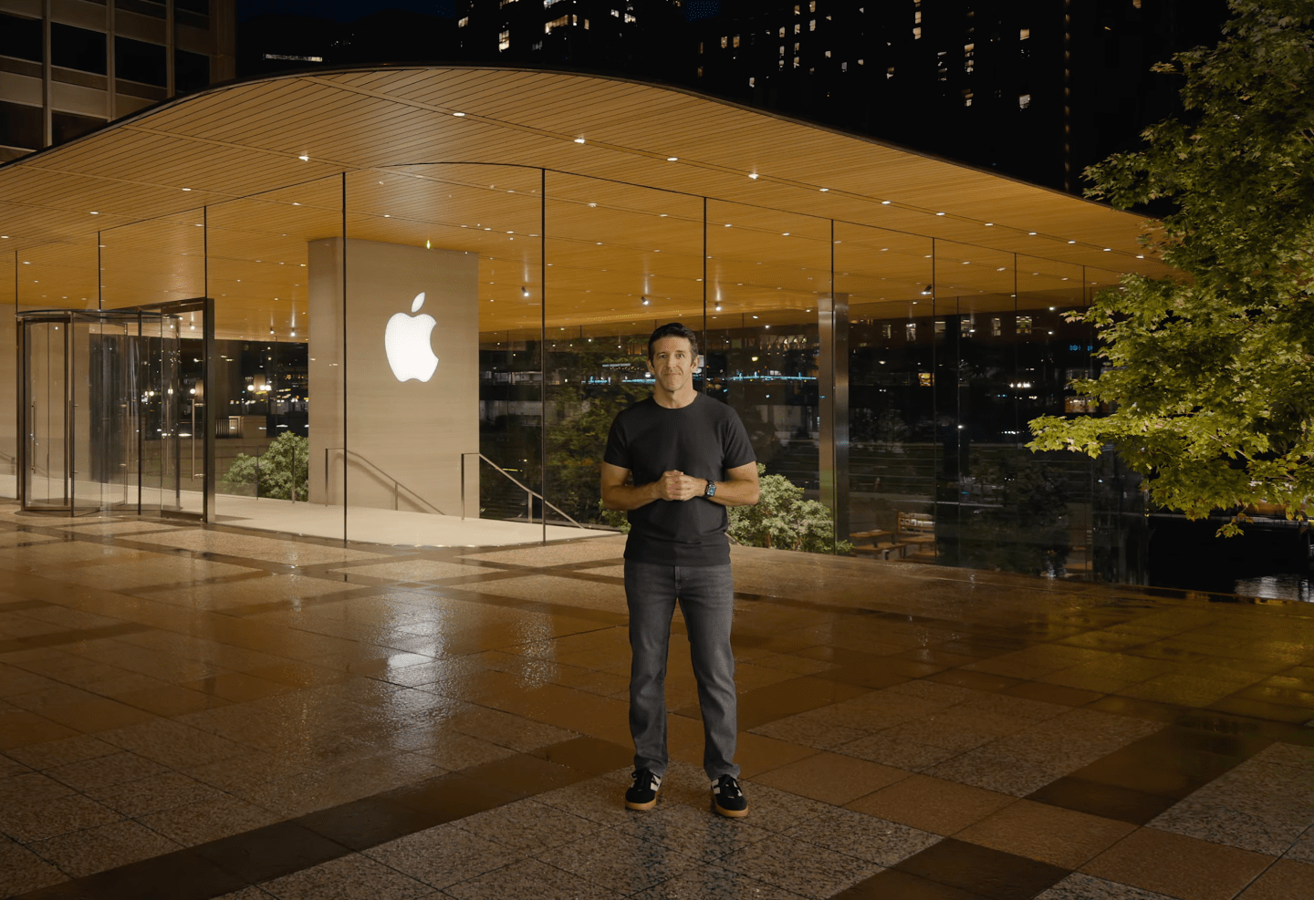 John Ternus stands in front of an Apple Store
