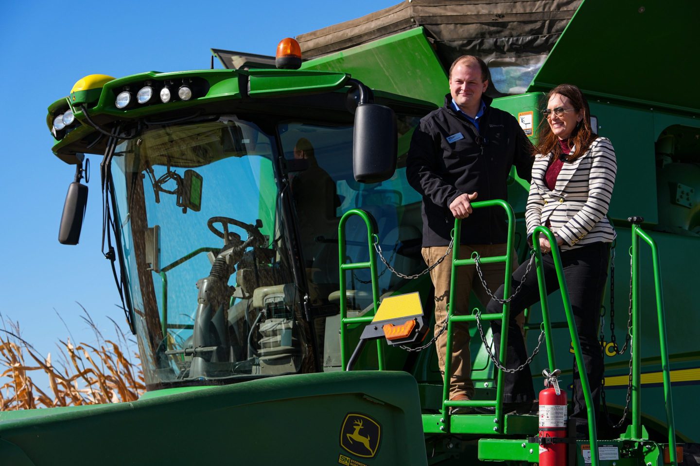 Secretary of Agriculture Brooke L. Rollins, right, films a social media post on a combine with farm owner Tyler Everett during a farm tour in Lebanon, Ind., Thursday, Oct. 30, 2025.