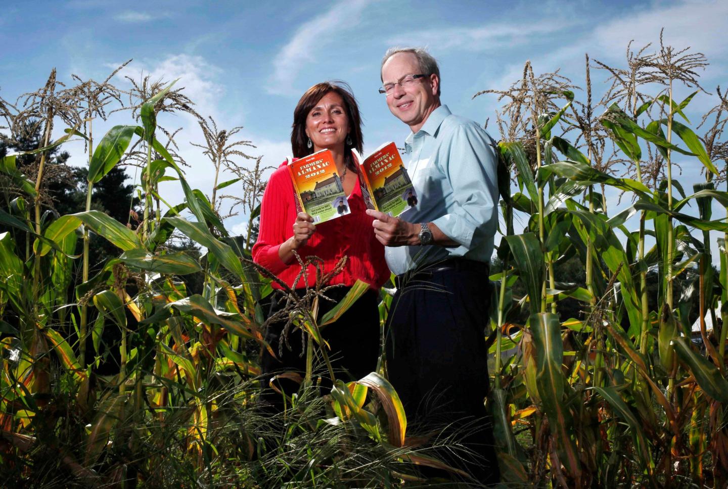 Farmers' Almanac editor Sondra Duncan and publisher Peter Geiger pose in a corn field with the 2012 edition of the almanac, Aug. 24, 2011, in Auburn, Maine.