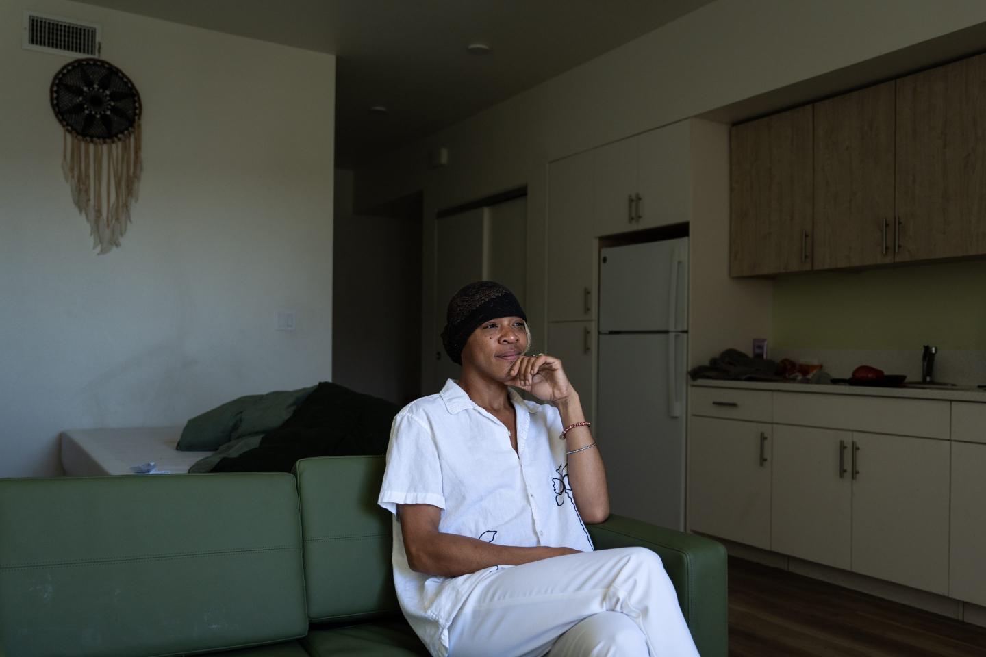 Quantavia Smith sits for a photo in her studio apartment at the Santa Monica and Vermont Apartments in Los Angeles, Monday, Nov. 10, 2025