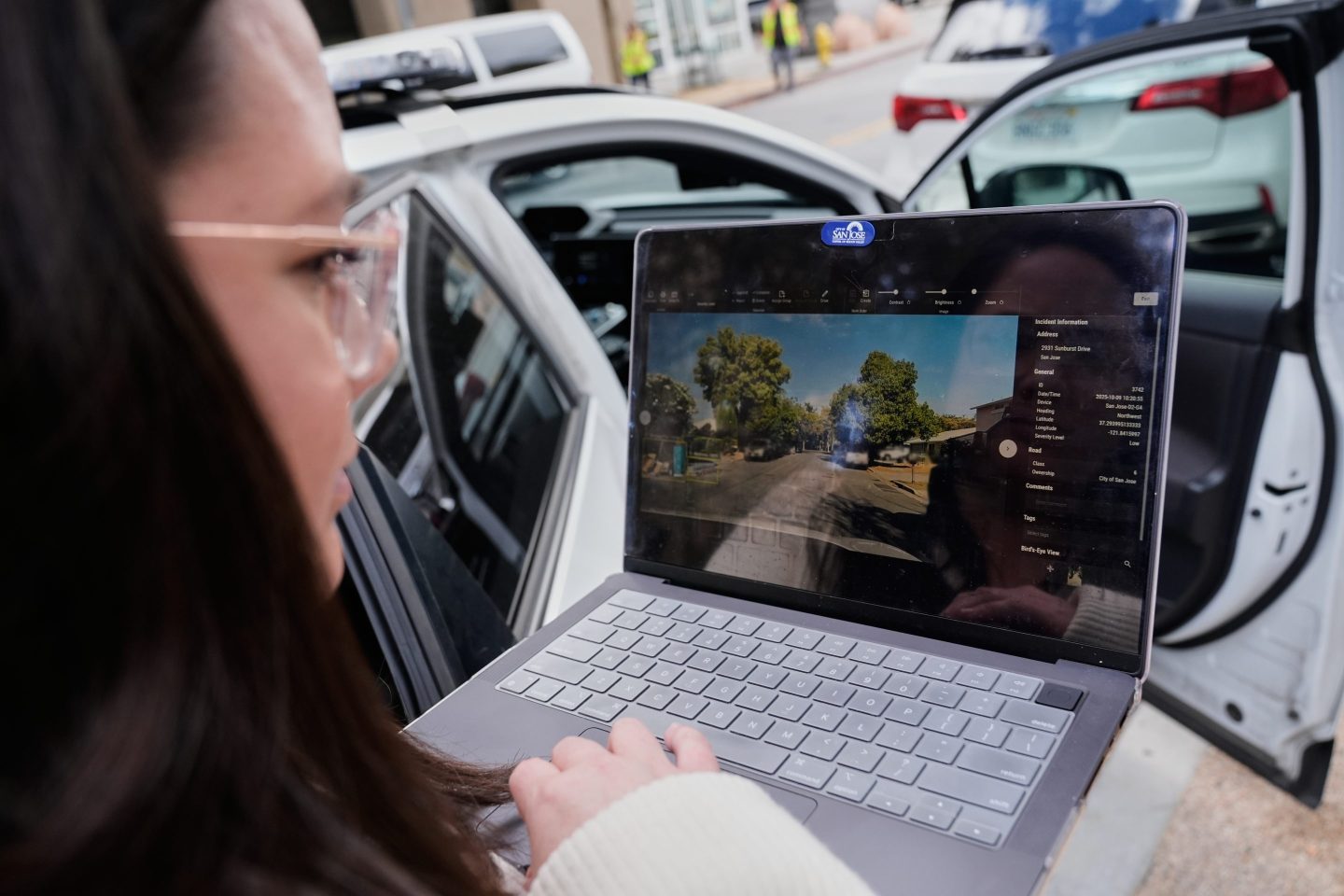 Chelsea Palacio, public information manager for the City of San Jose, showcases how a small detection camera uses AI to detect road hazards and potholes, in San Jose, Calif., Wednesday, Nov. 12, 2025.