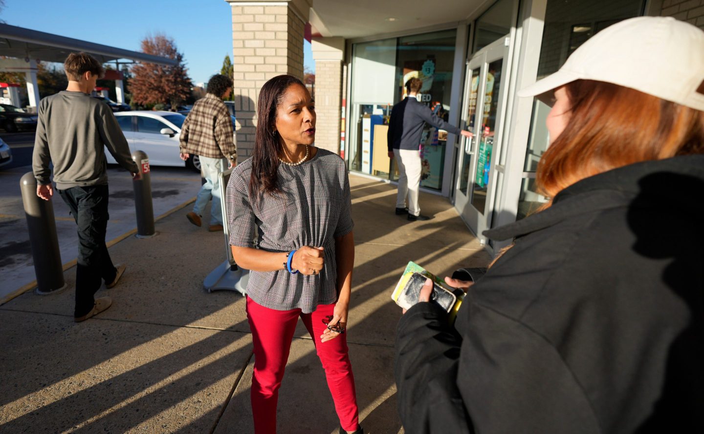 Virginia House of Delegates, Del.-elect, Nicole Cole, center, speaks with constituent Kaitlyn Sapp, at a convince store Thursday, Nov. 13, 2025, in Fredericksburg, Va.