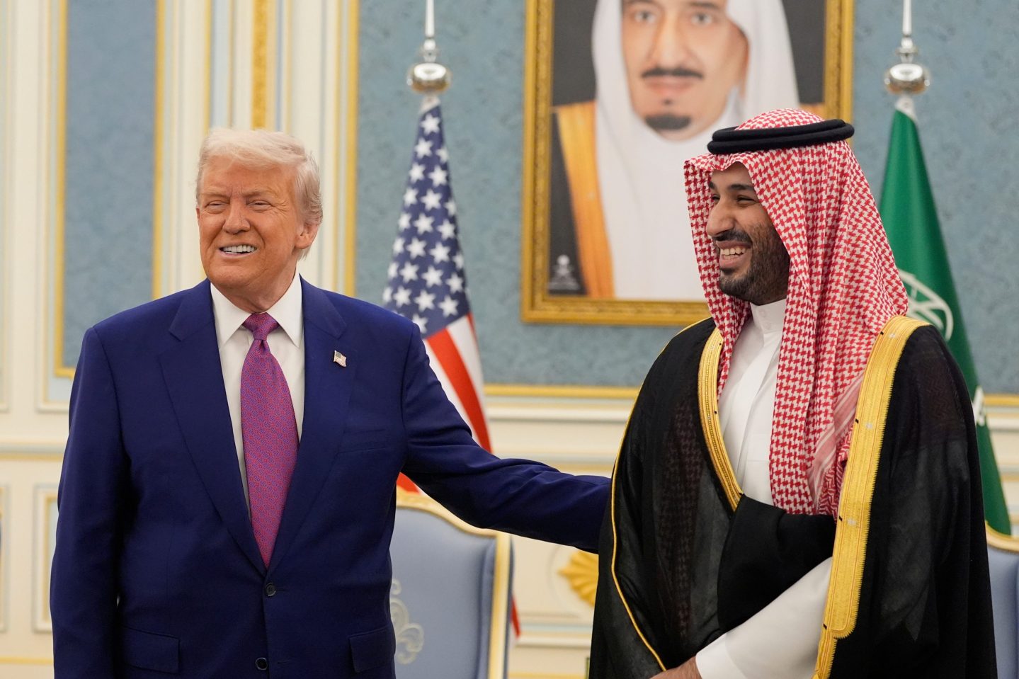 President Donald Trump and Saudi Crown Prince Mohammed bin Salman gesture as they meet delegations at the Royal Palace in Riyadh, Saudi Arabia, May 13, 2025.