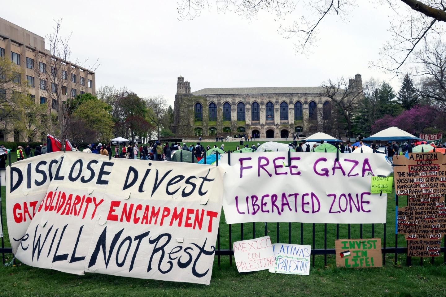 Signs protesting Israel's occupation of Gaza are displayed outside a tent encampment at Northwestern University in April 2024.