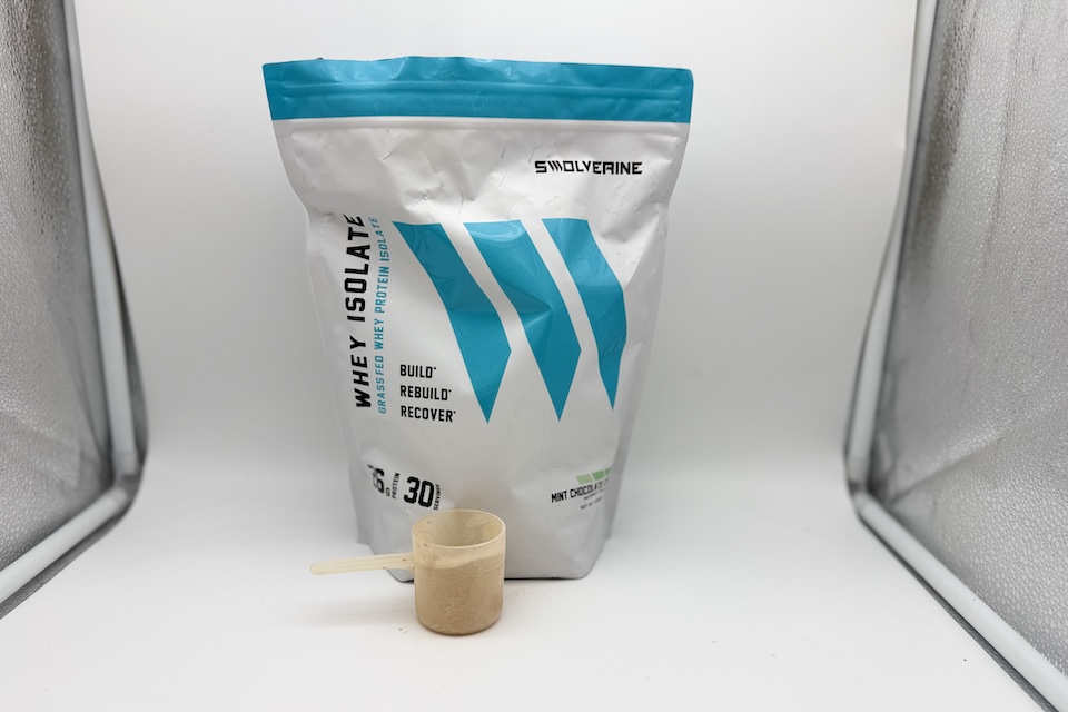 A bag of Swolverine Whey Isolate Powder sitting on a counter with a scooper sitting in front of it.