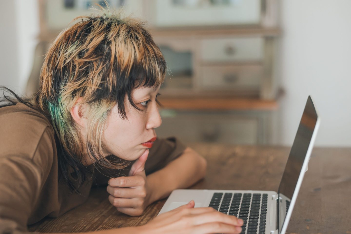 Close up shot of young Gen-Z female with colorful hair at a cafe