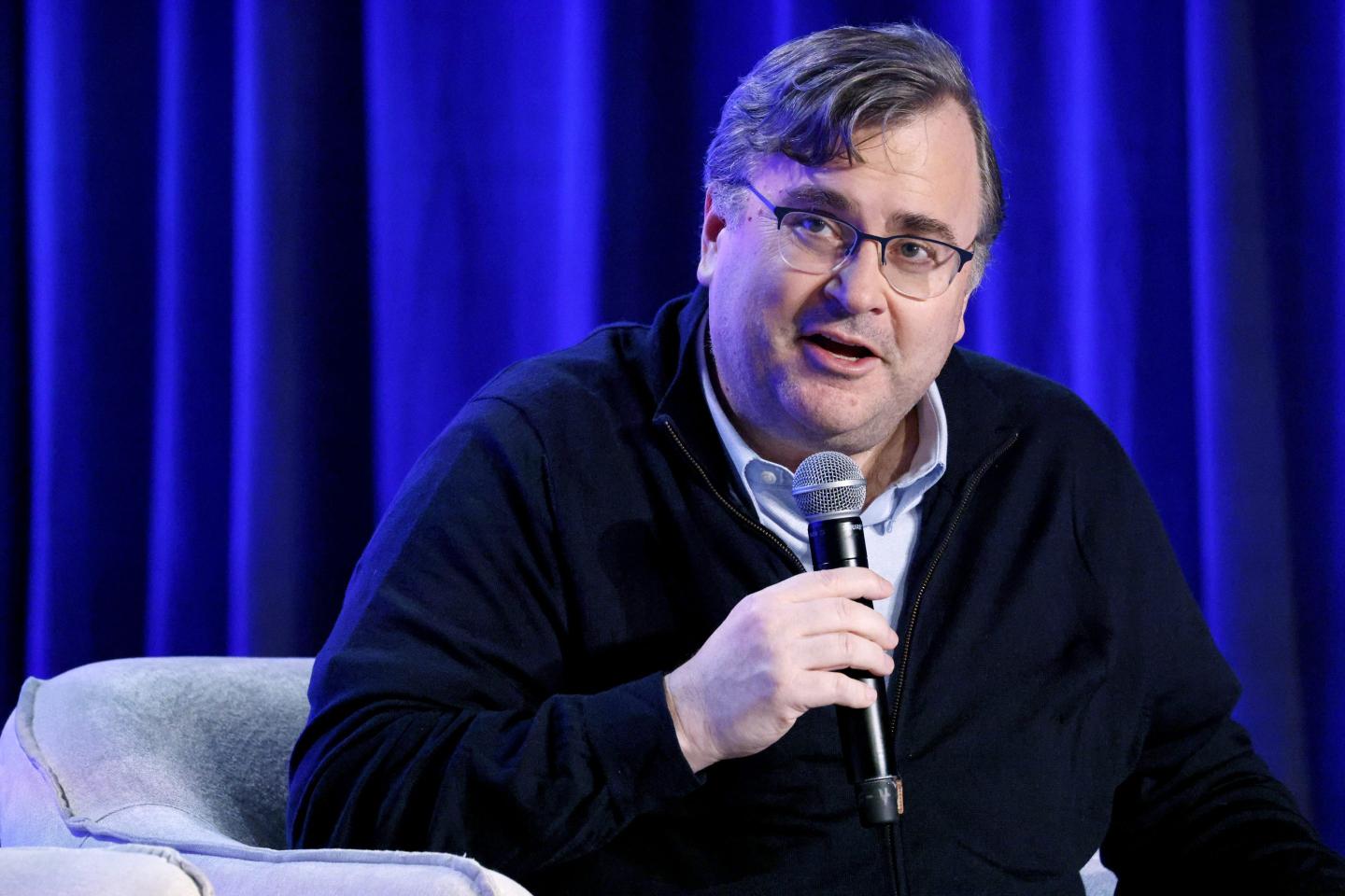 Reid Hoffman speaks into a microphone