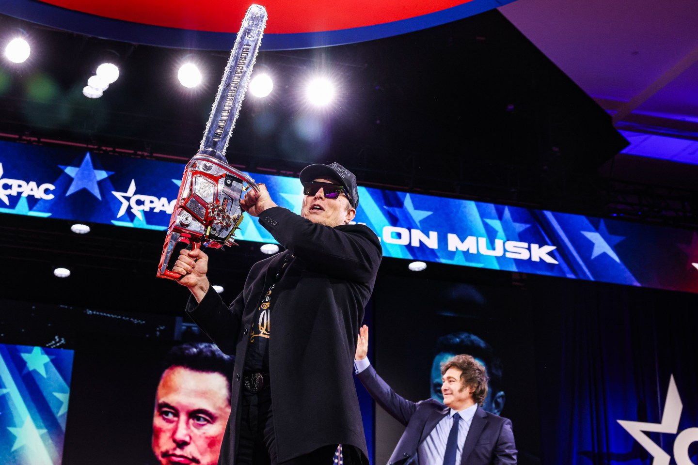 Elon Musk raises a chainsaw at the Conservative Political Action Conference (CPAC) in Oxon Hill, Maryland on February 20, 2025. (Photo: Valerie Plesch/ Washington Post/Getty Images)