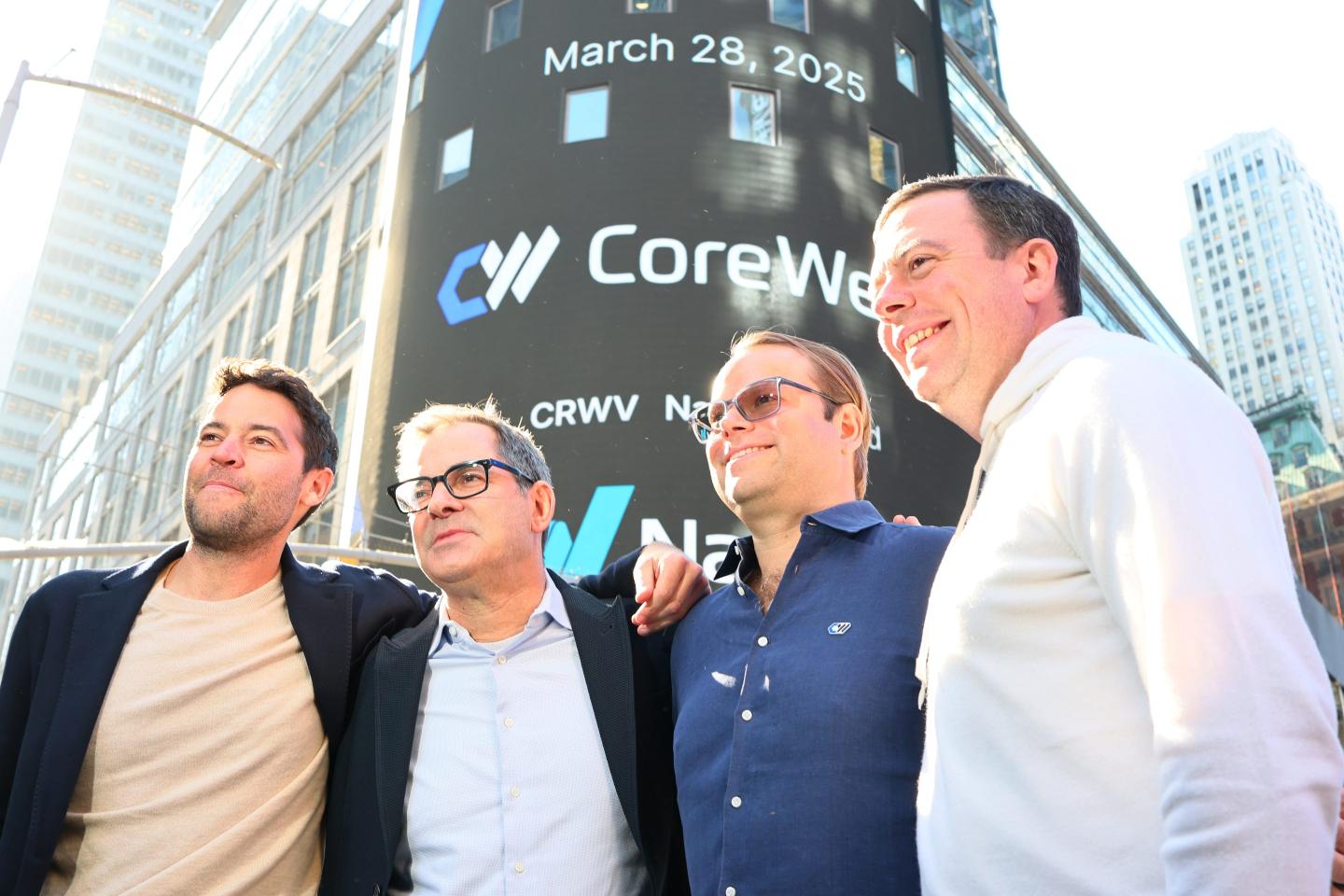 CoreWeave executives pose in front of the Nasdaq building on the day of the company's IPO.